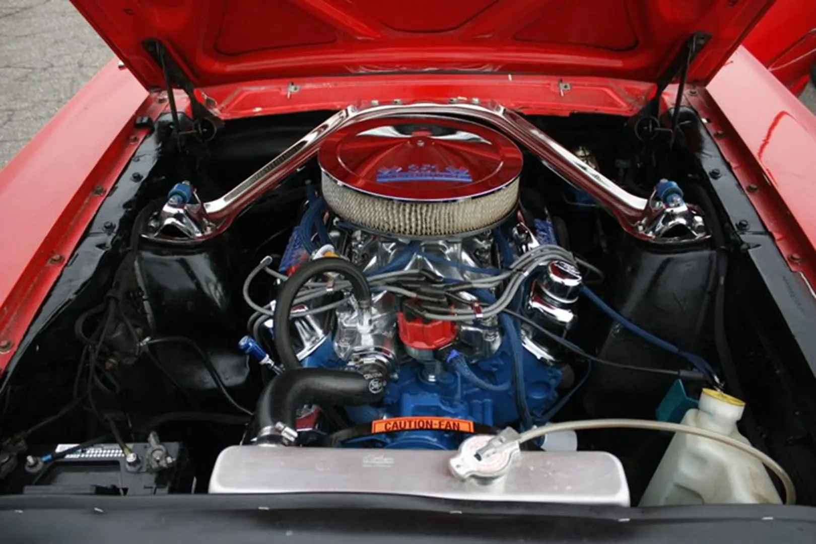 Red car engine with chrome details