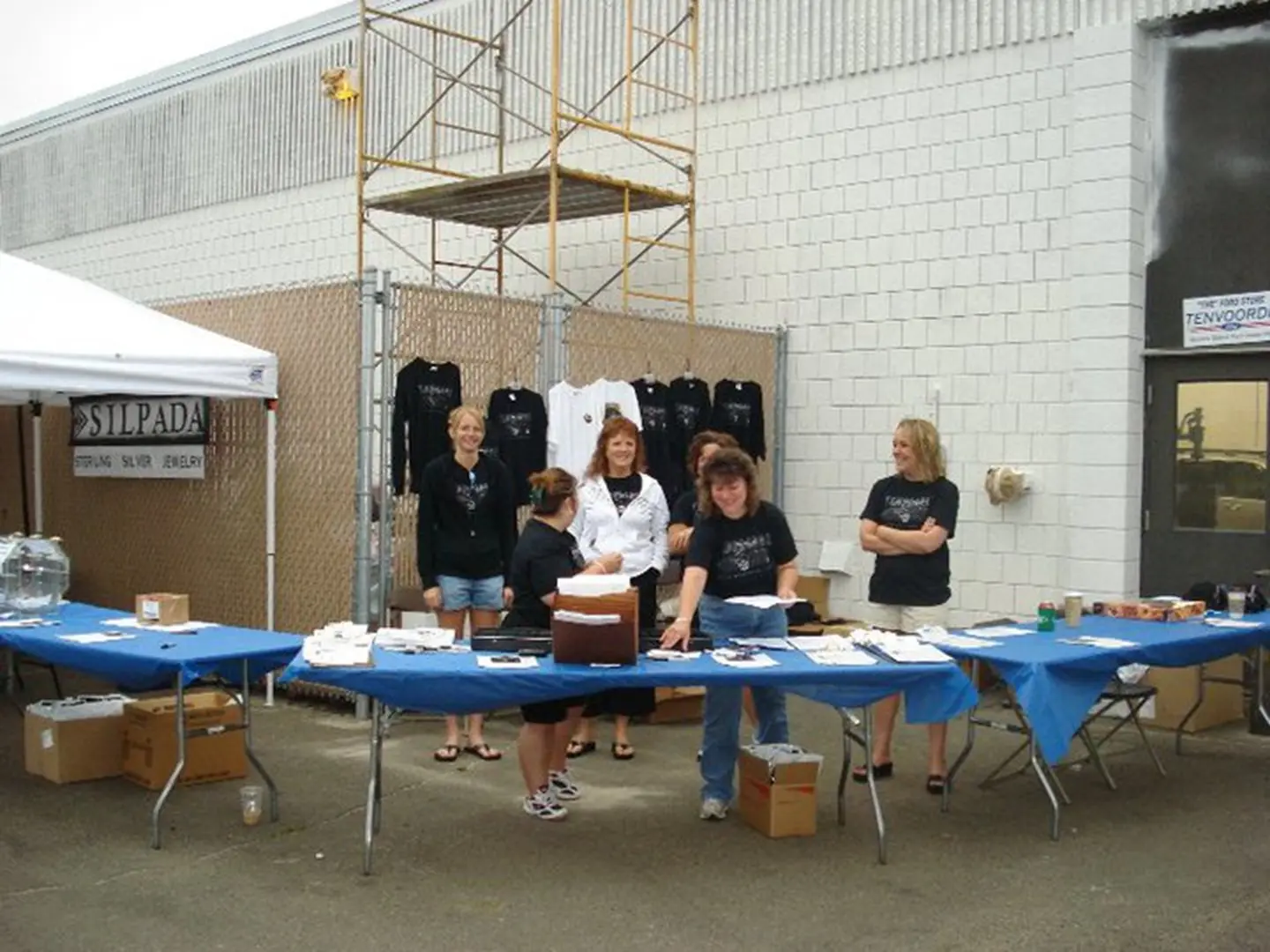 Outdoor event booth with blue tablecloths
