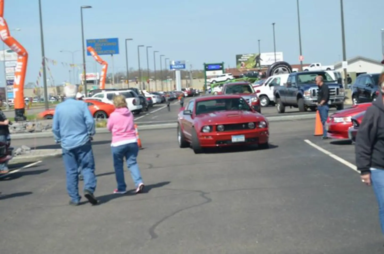 People walking near parked cars