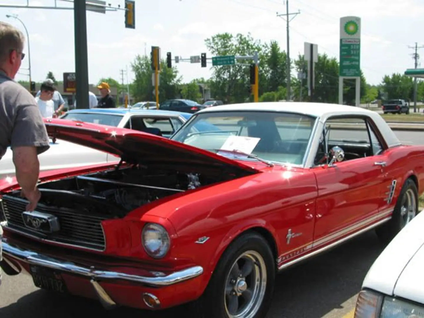 Red classic car with open hood
