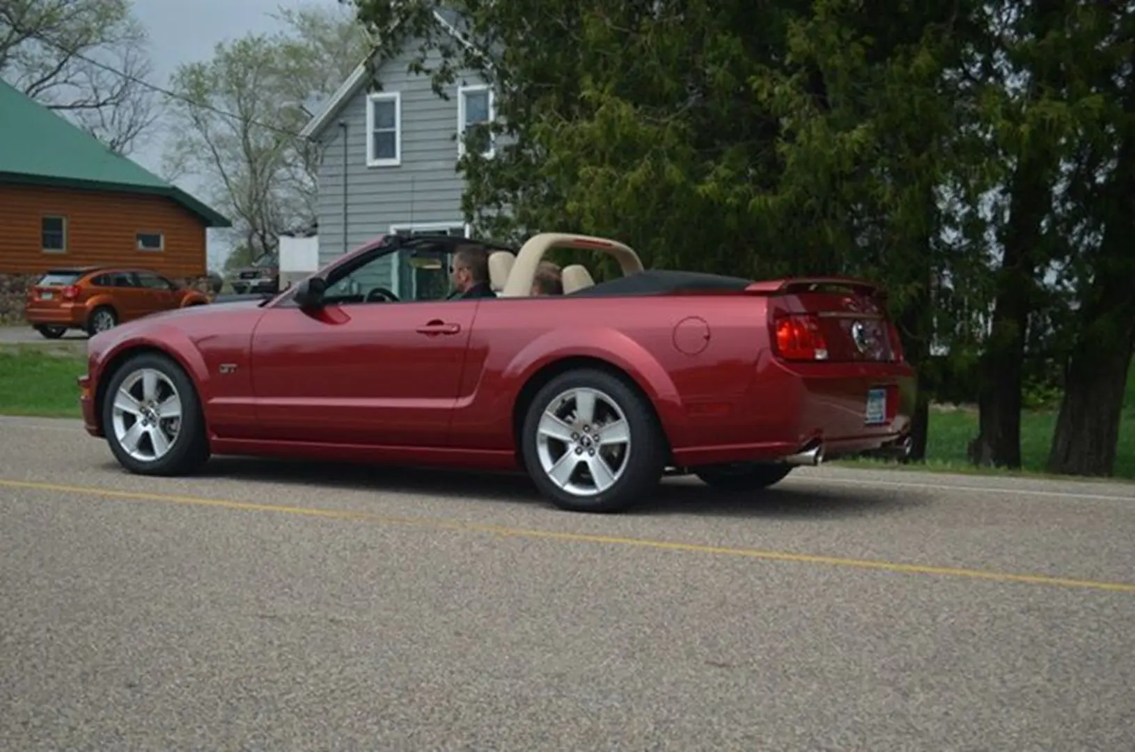 Red convertible parked on rural road