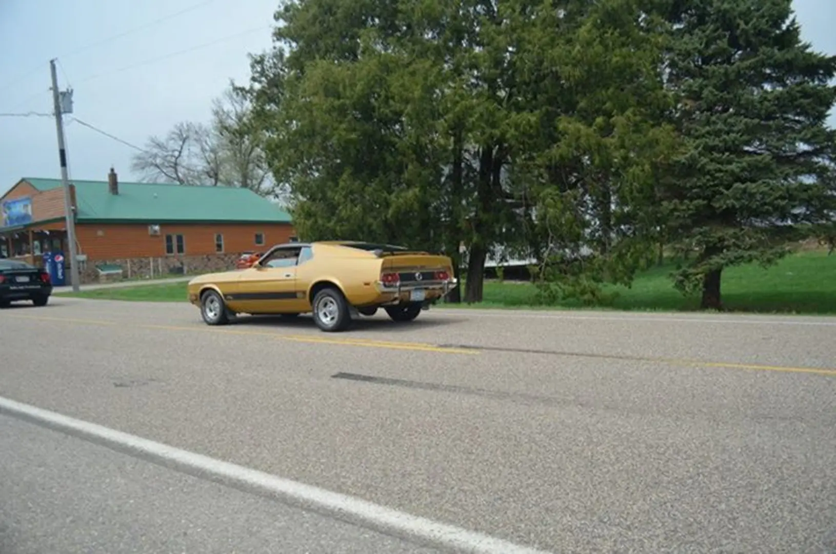 Yellow classic car on rural road