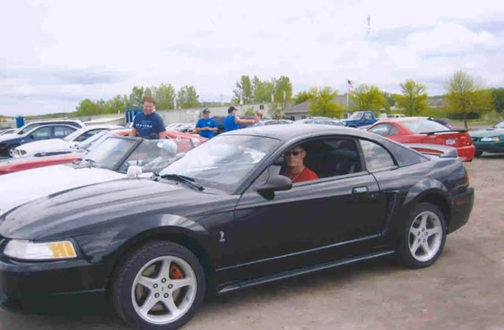 Black sports car at outdoor car meet