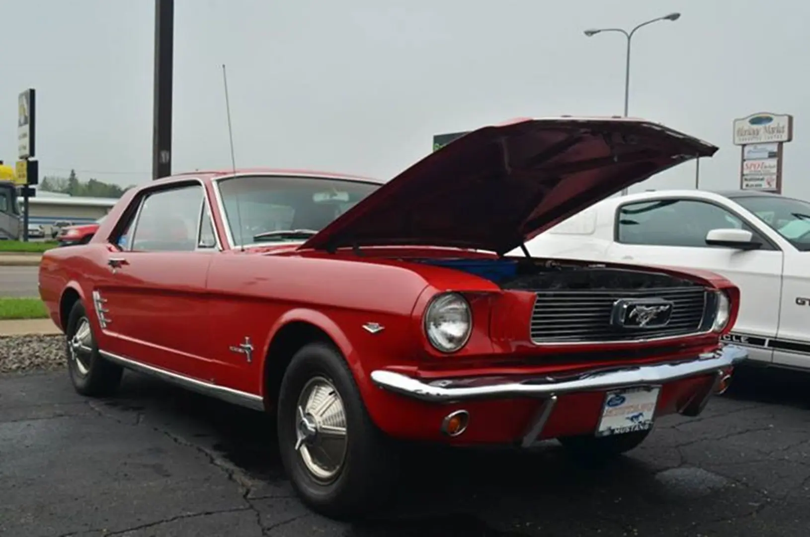 Red classic car with hood open