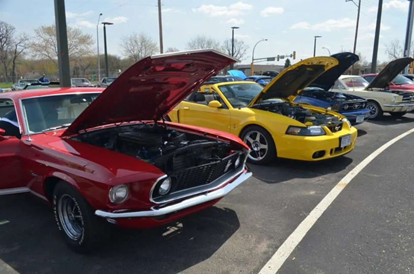 Red and yellow cars at a car show