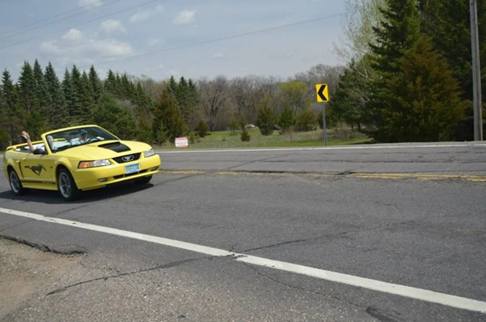 Bright yellow car on countryside road