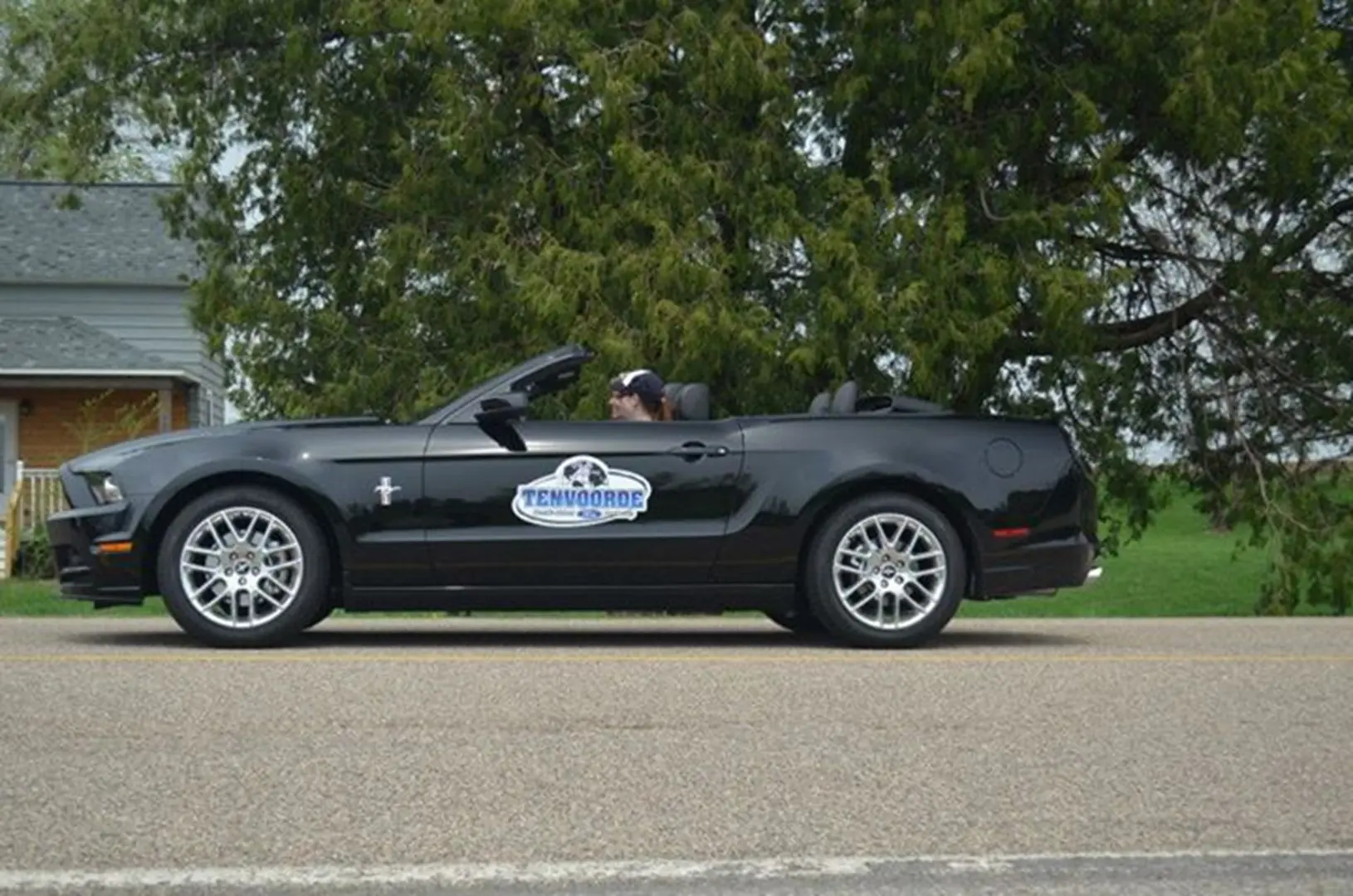 Black convertible car parked on road