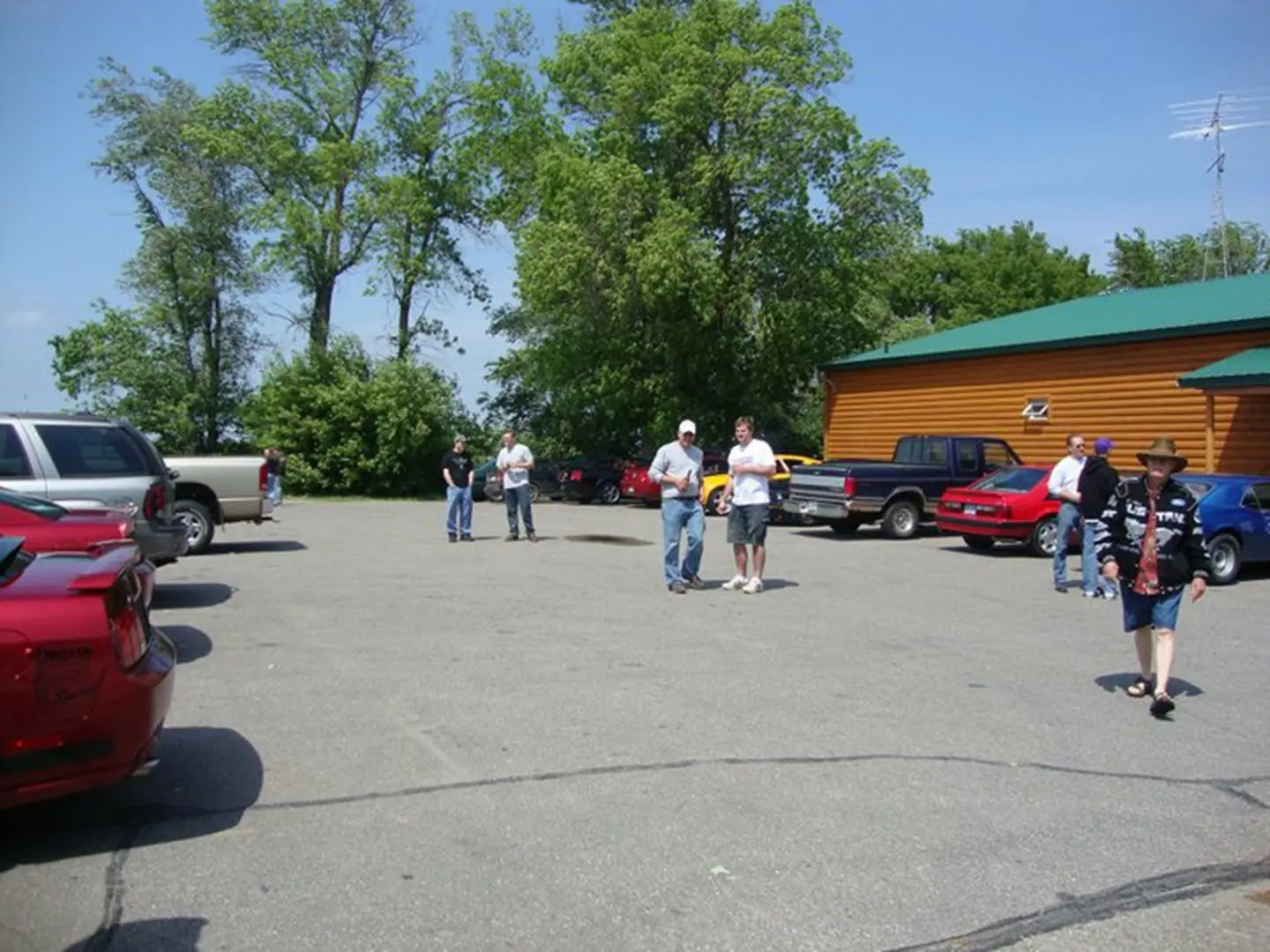 People in parking lot near building