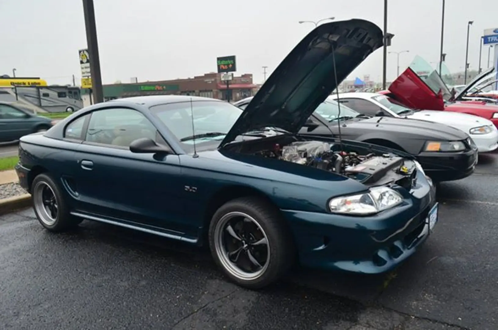 Blue sports car with hood open