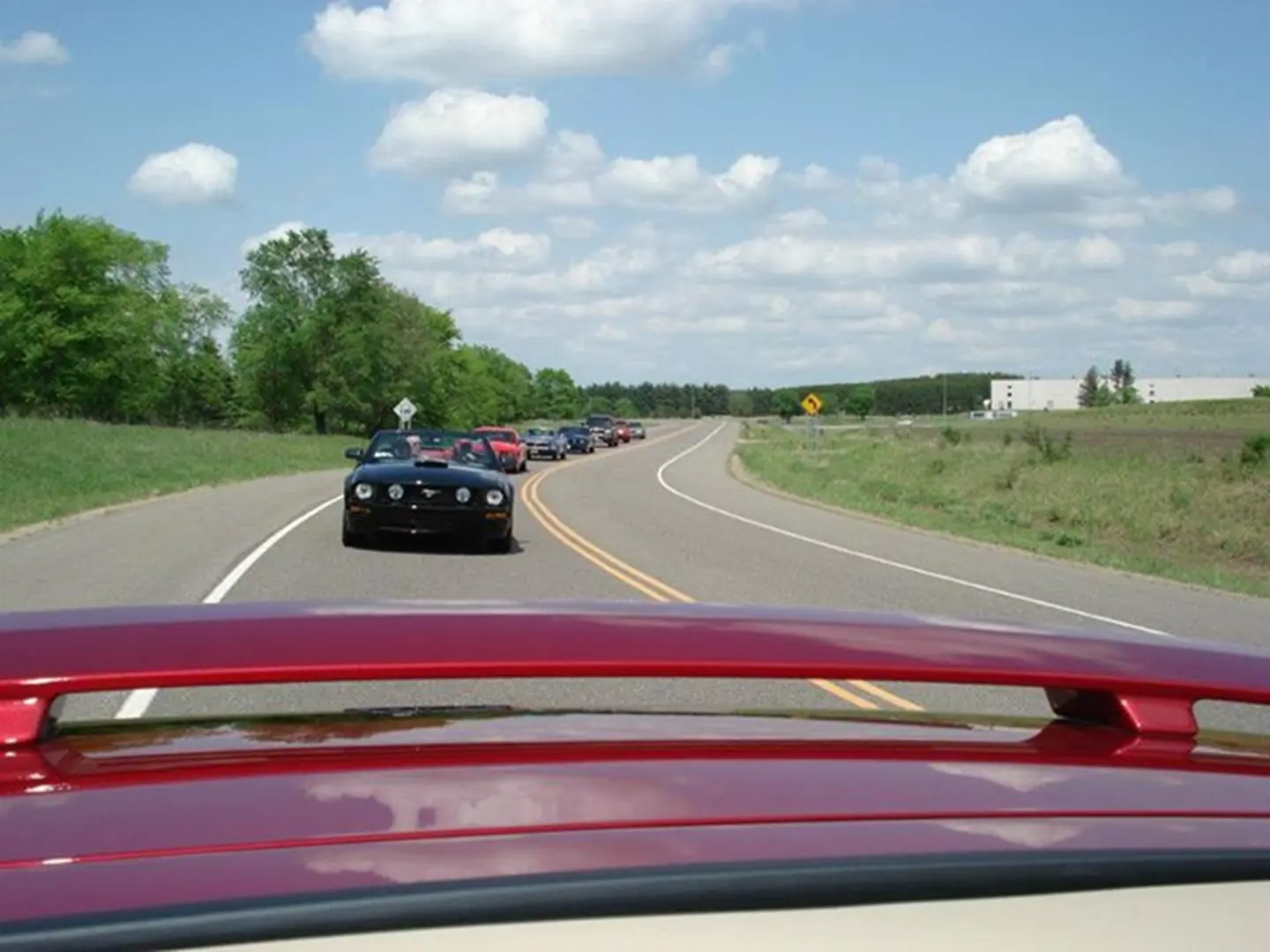 Convoy of cars under a cloudy sky