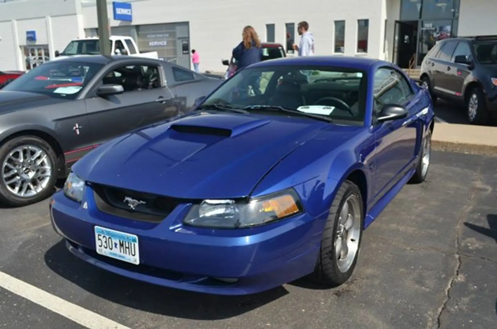 Shiny blue car with hood scoop