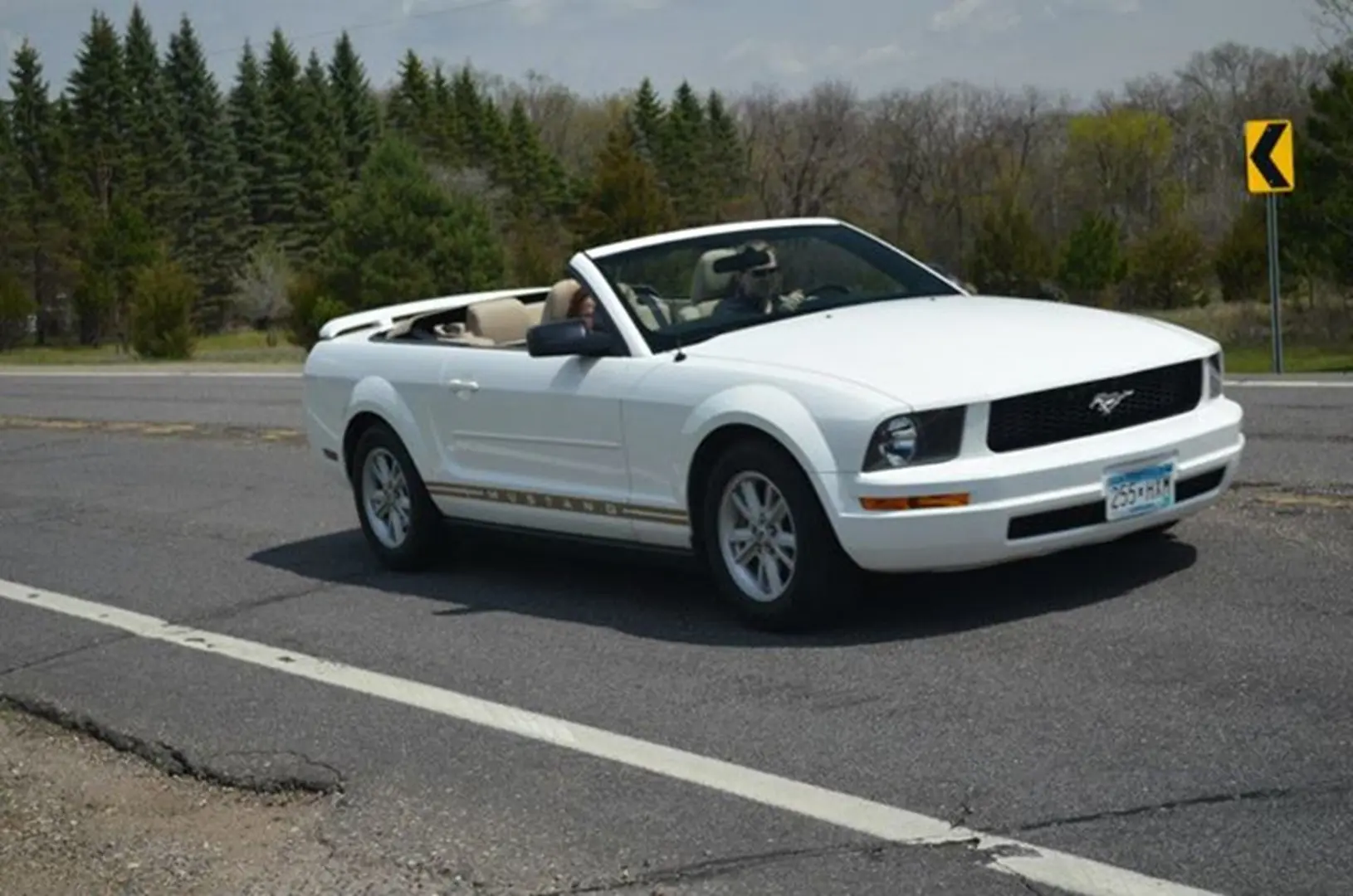 White convertible car on a rural road