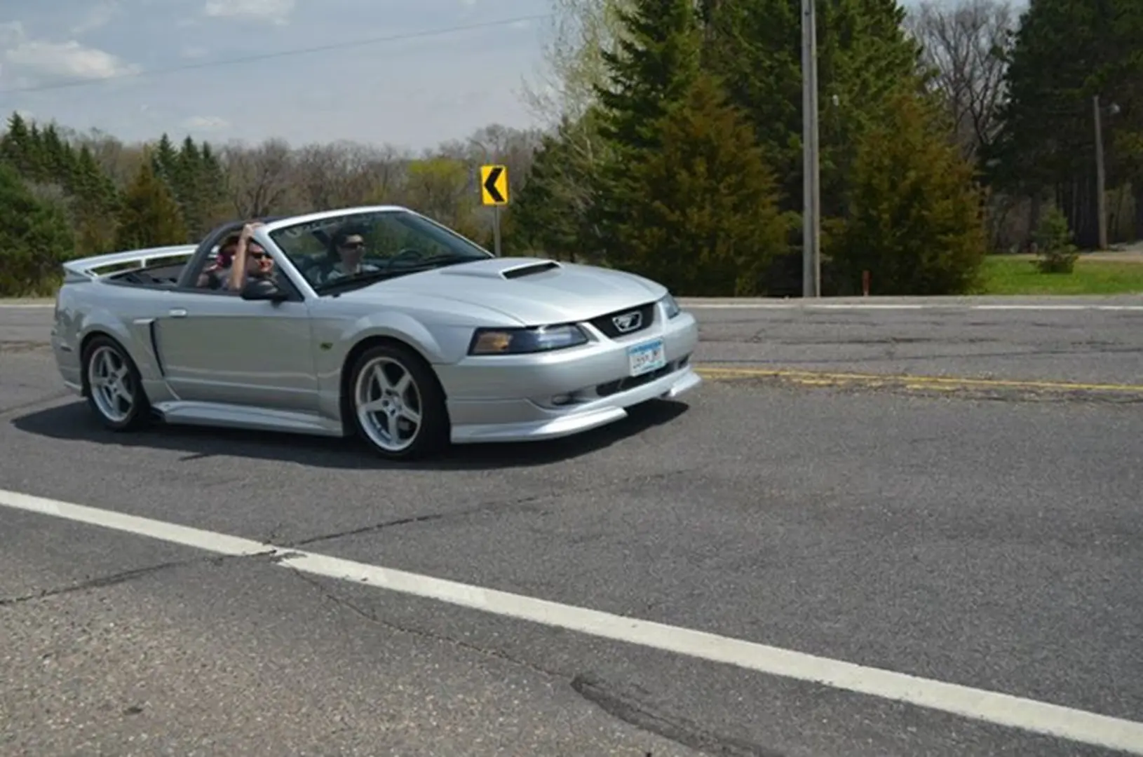 Open-top vehicle cruising in sunlight