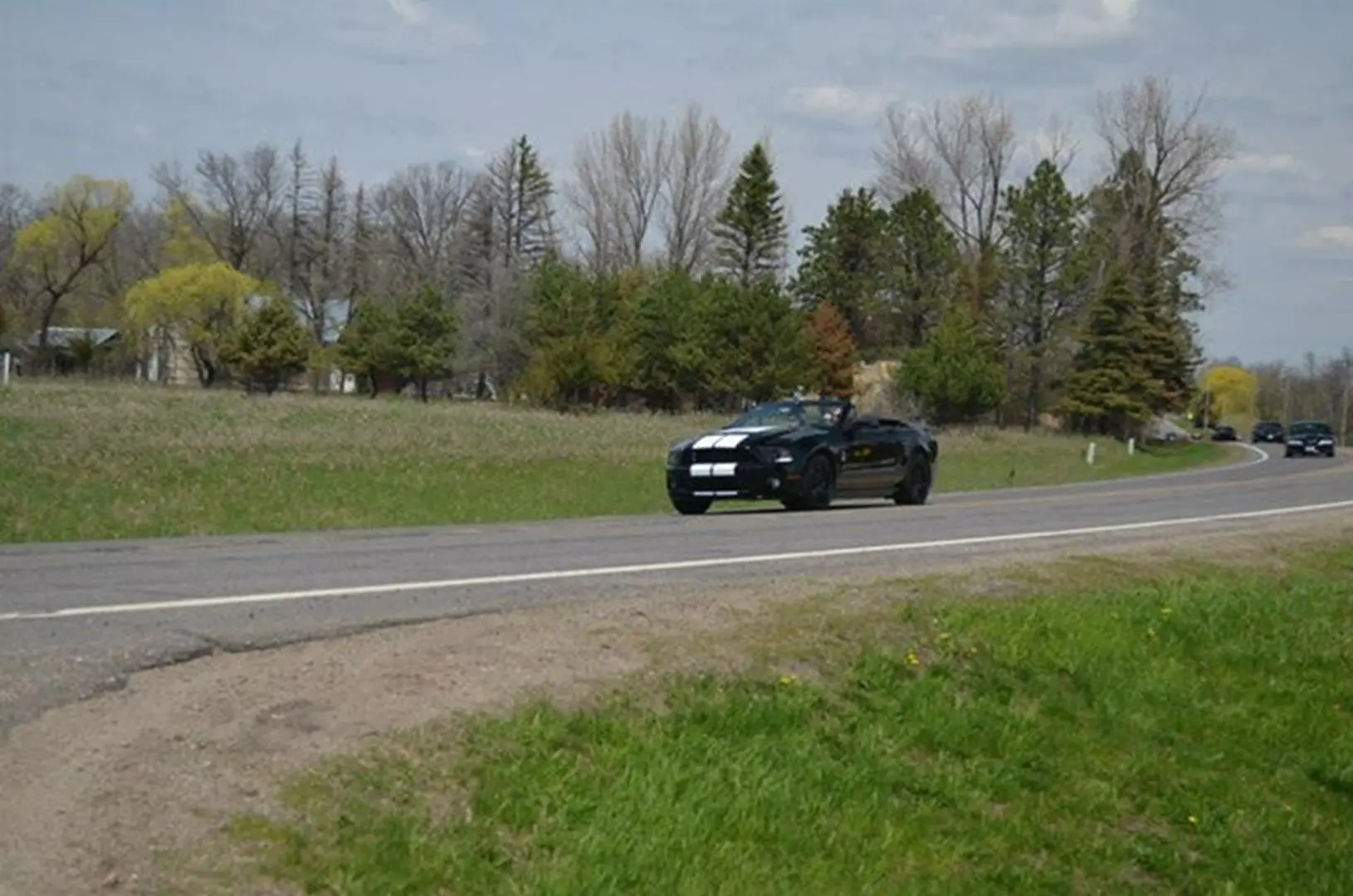 Black car driving on rural road