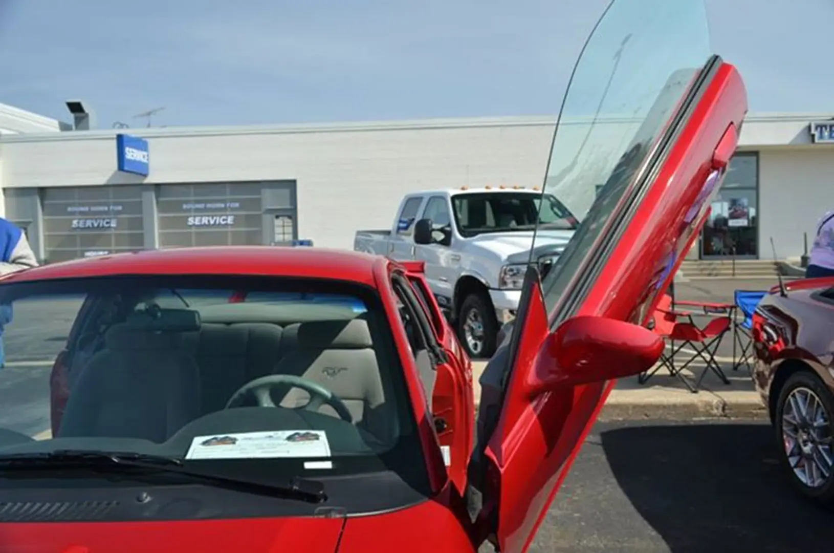 Sports car with open vertical door