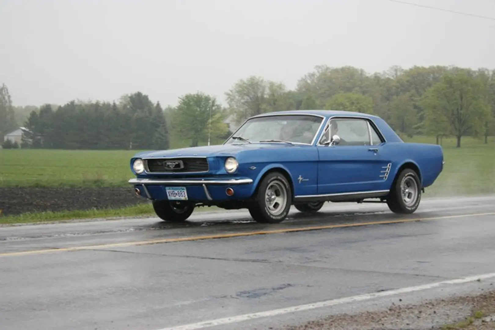 Classic car cruising through countryside