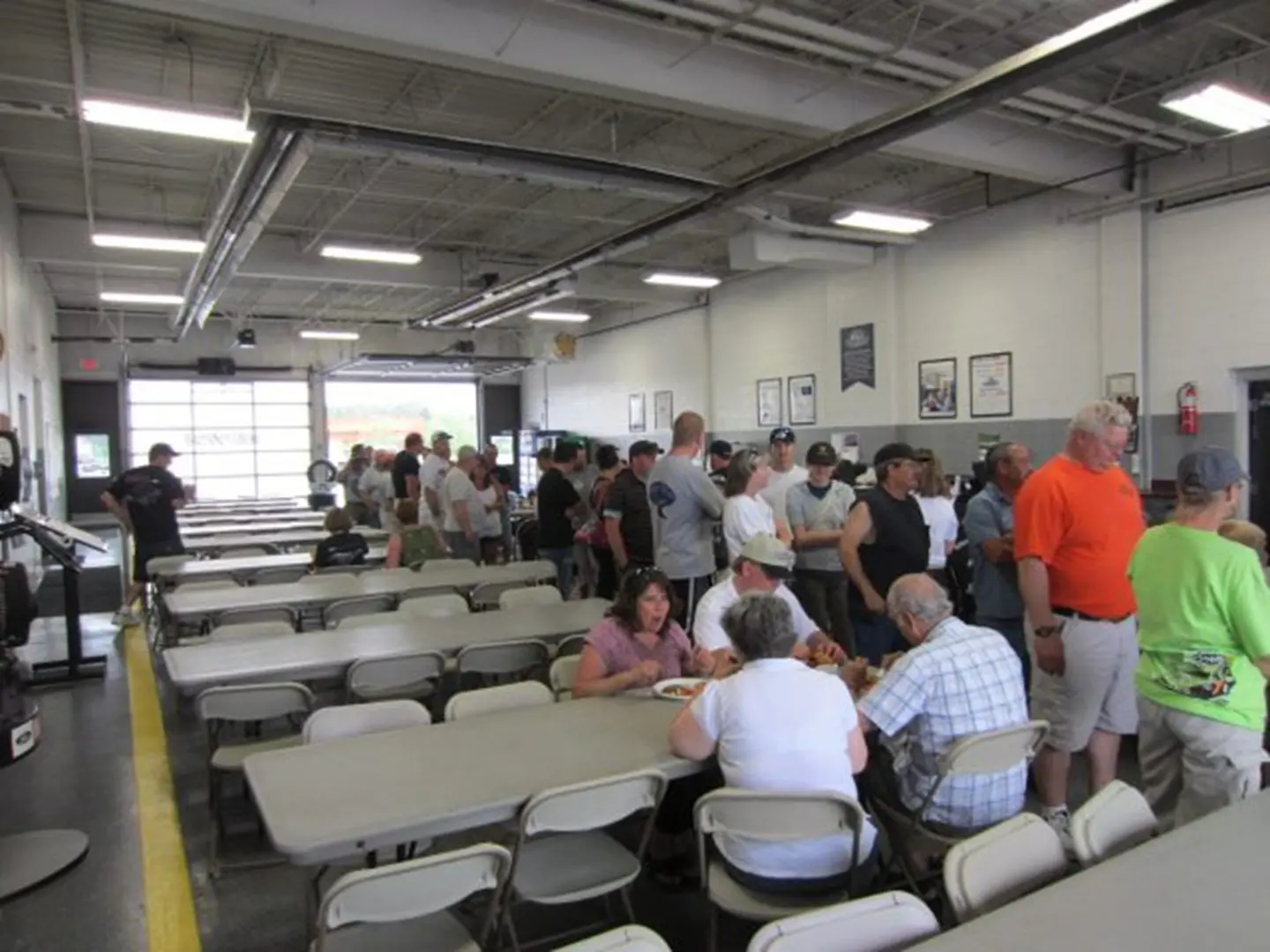 Indoor cafeteria with seated and standing guests