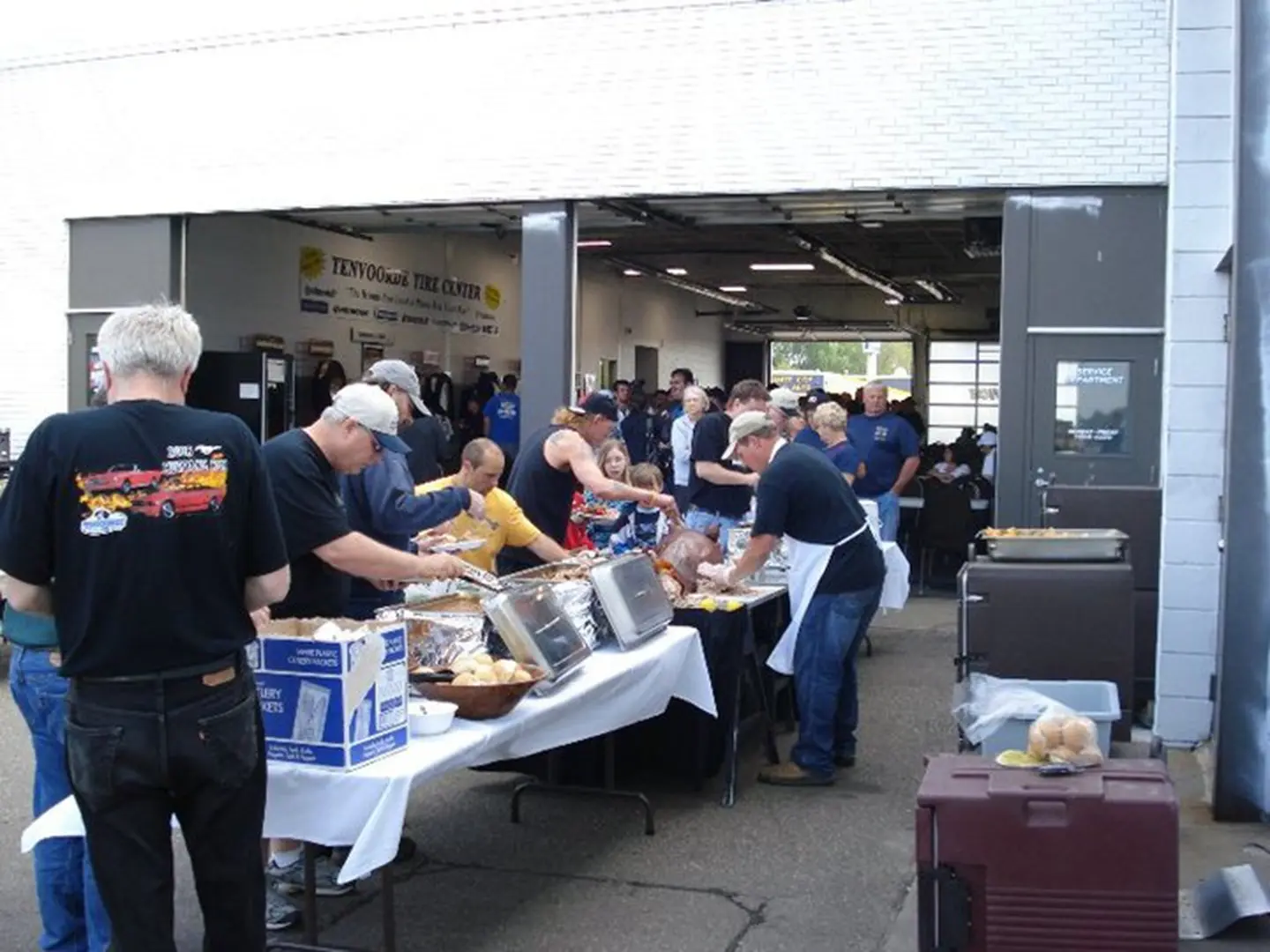 People serving food at a community event