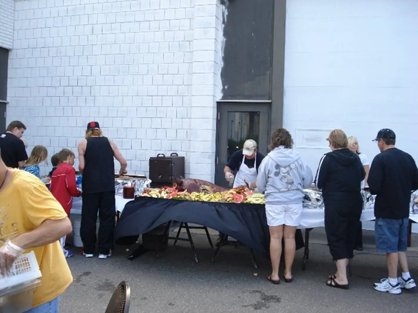 Outdoor buffet with people serving food