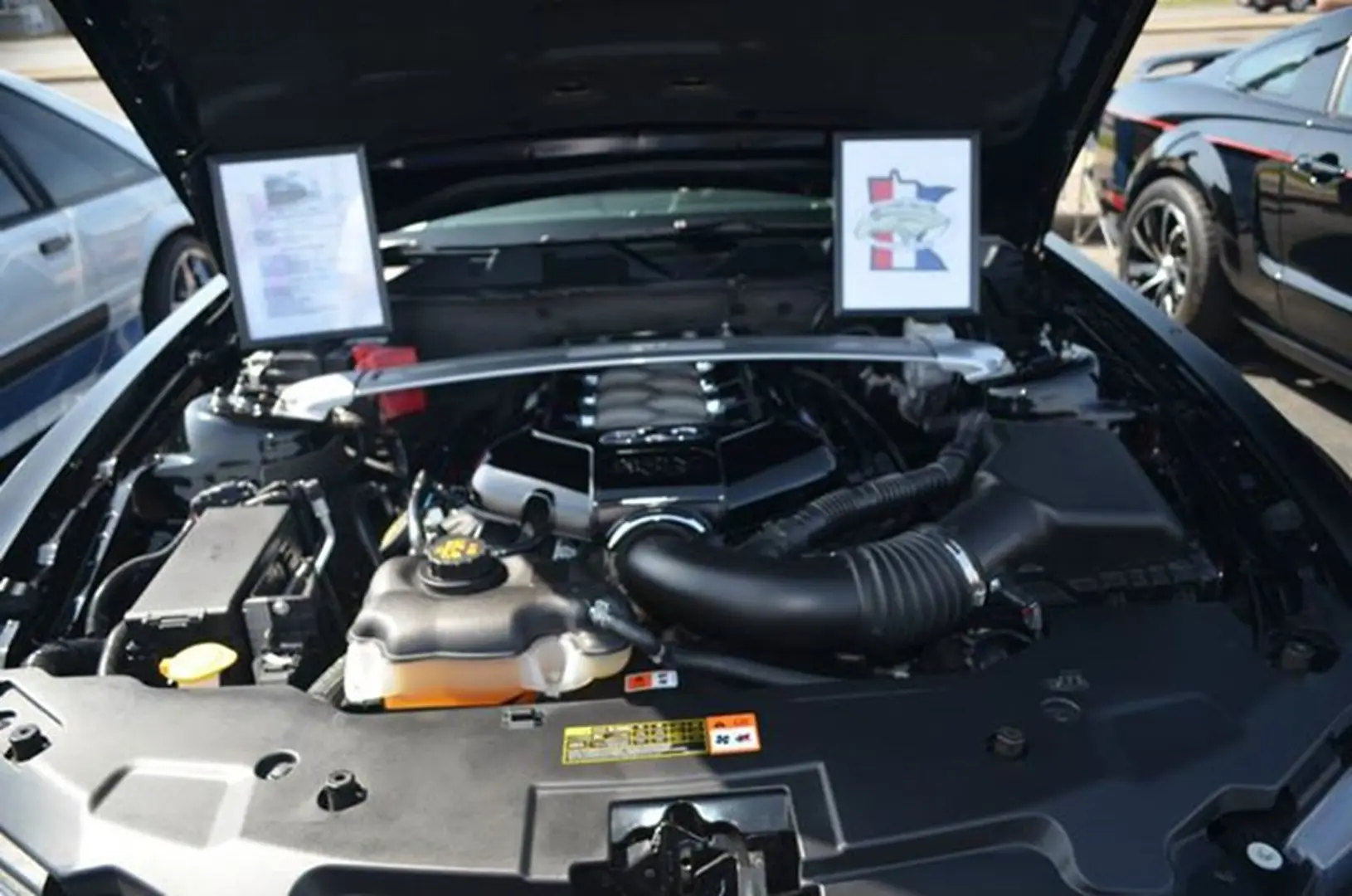Open car engine with displayed information