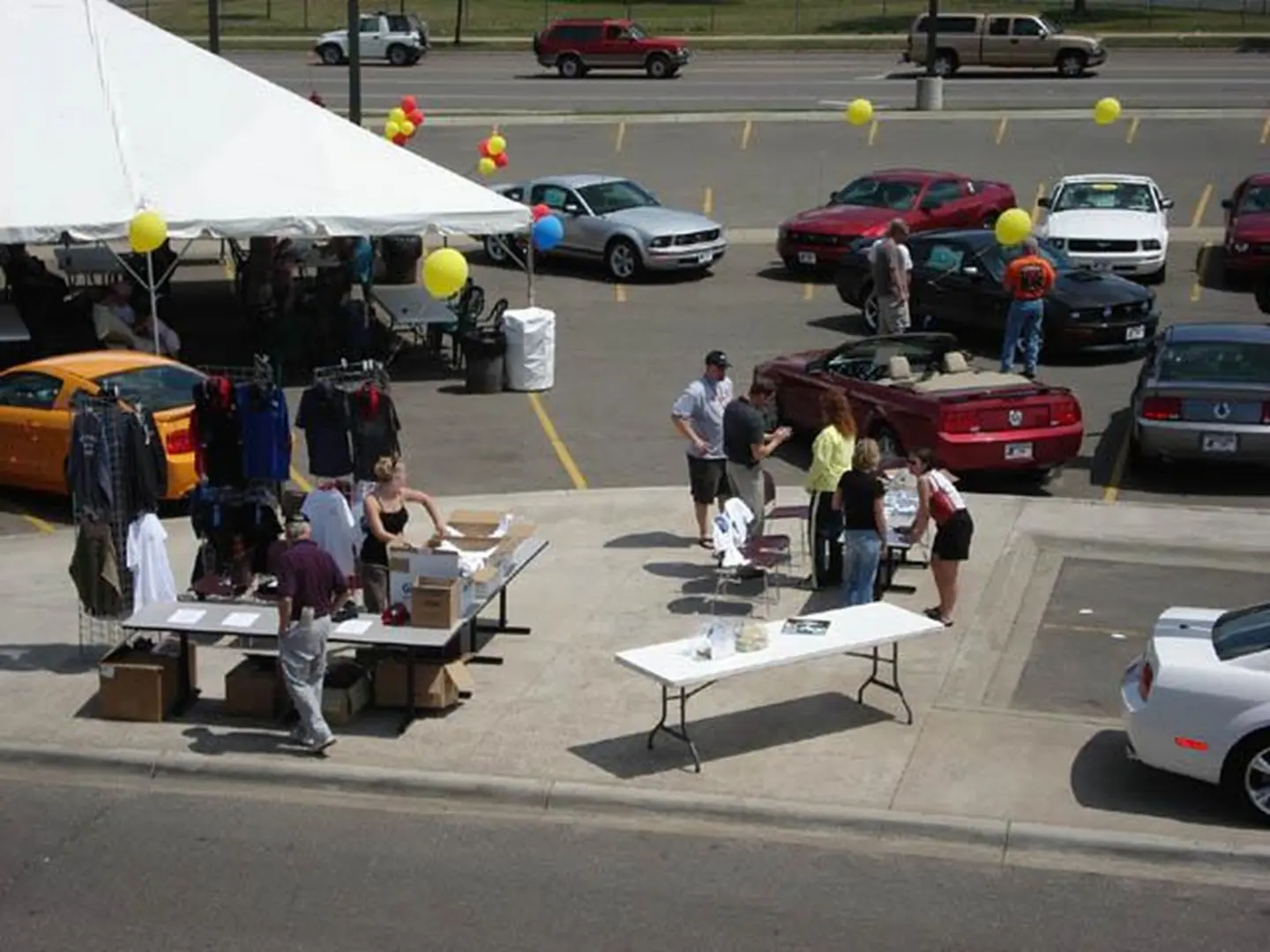Parking lot sale with balloons and tables