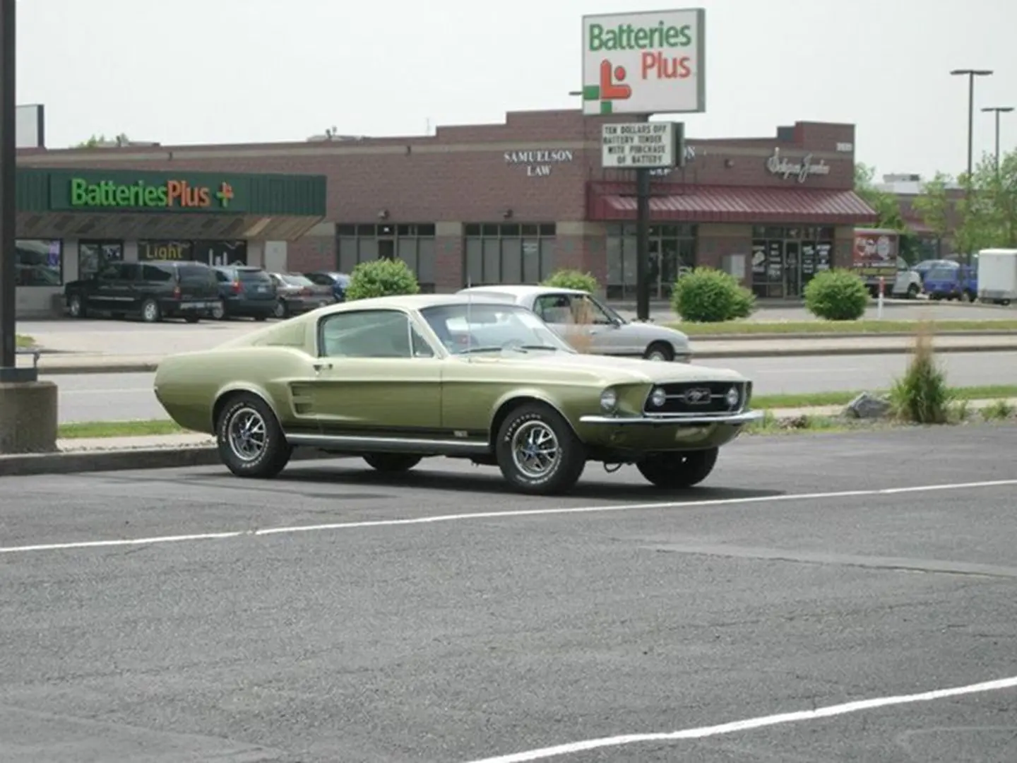 Retro car by Batteries Plus storefront.
