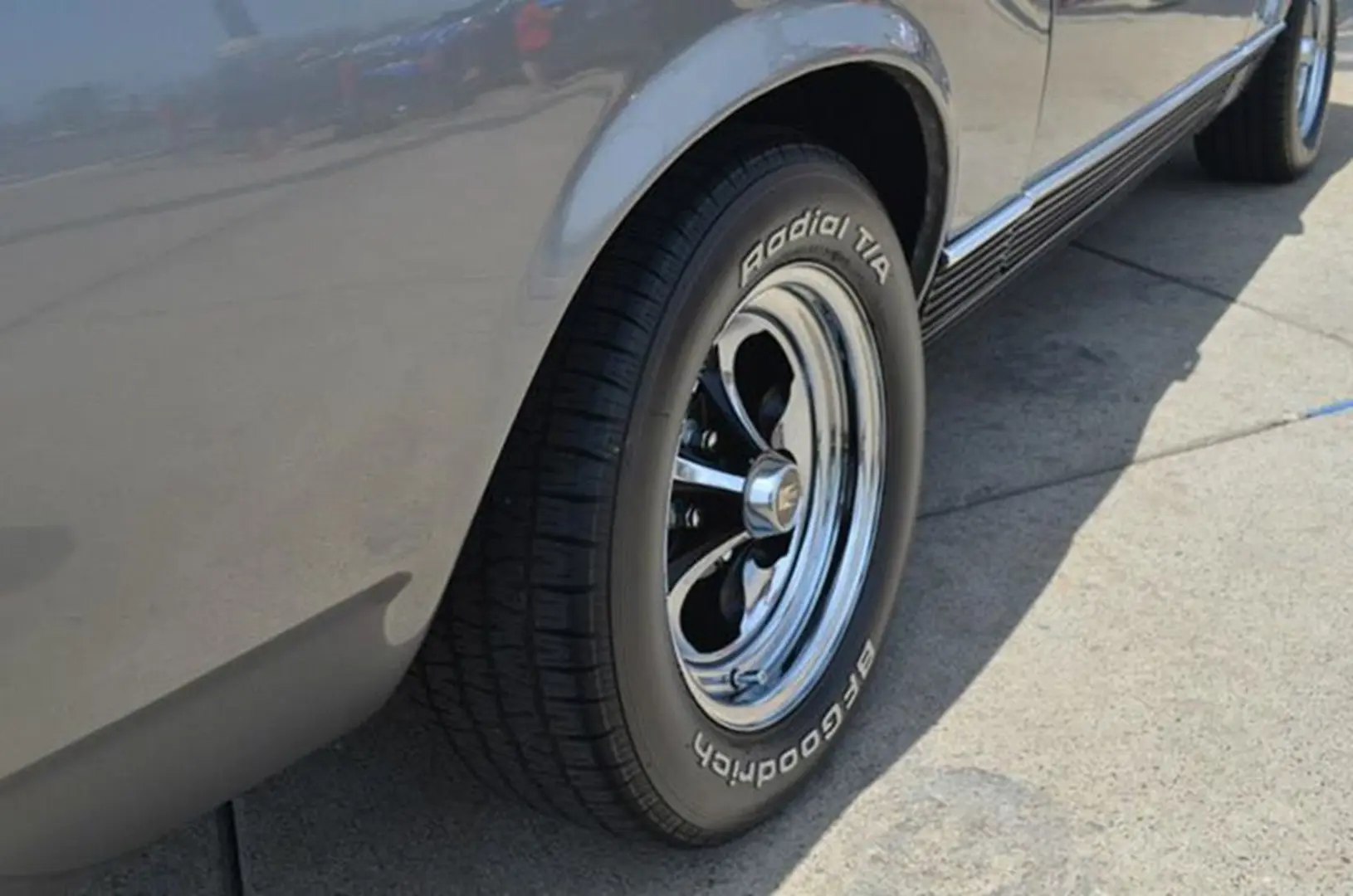 Car tire with shiny chrome wheel