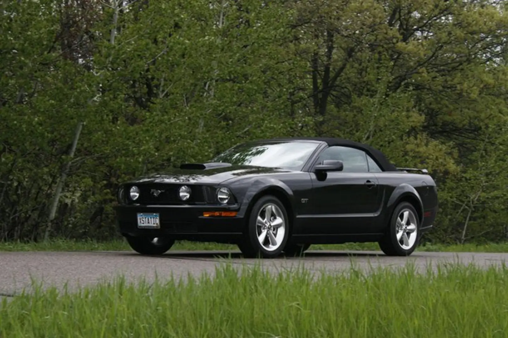 Sleek black sports car in nature setting