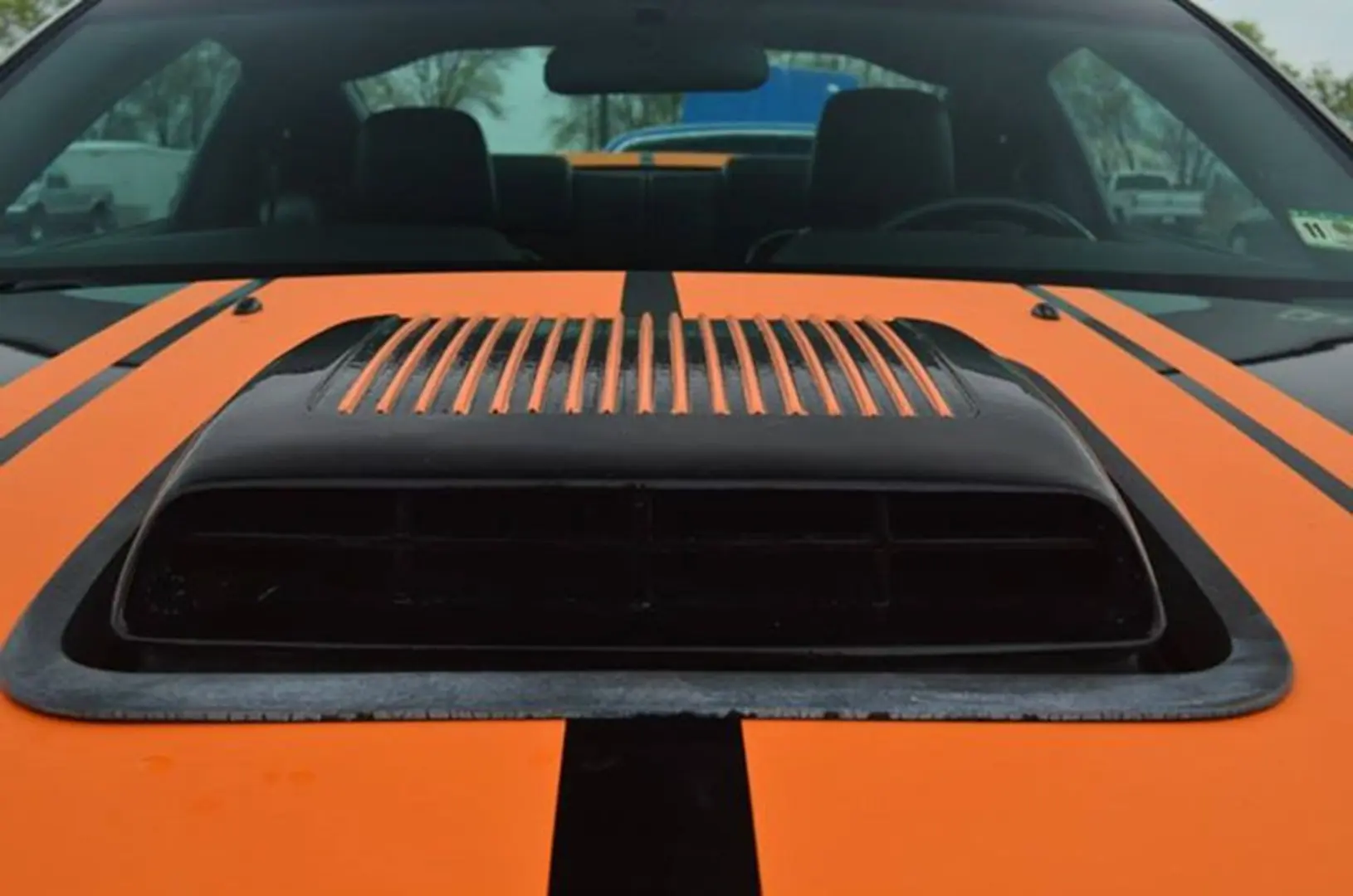 Orange car hood with black air intake
