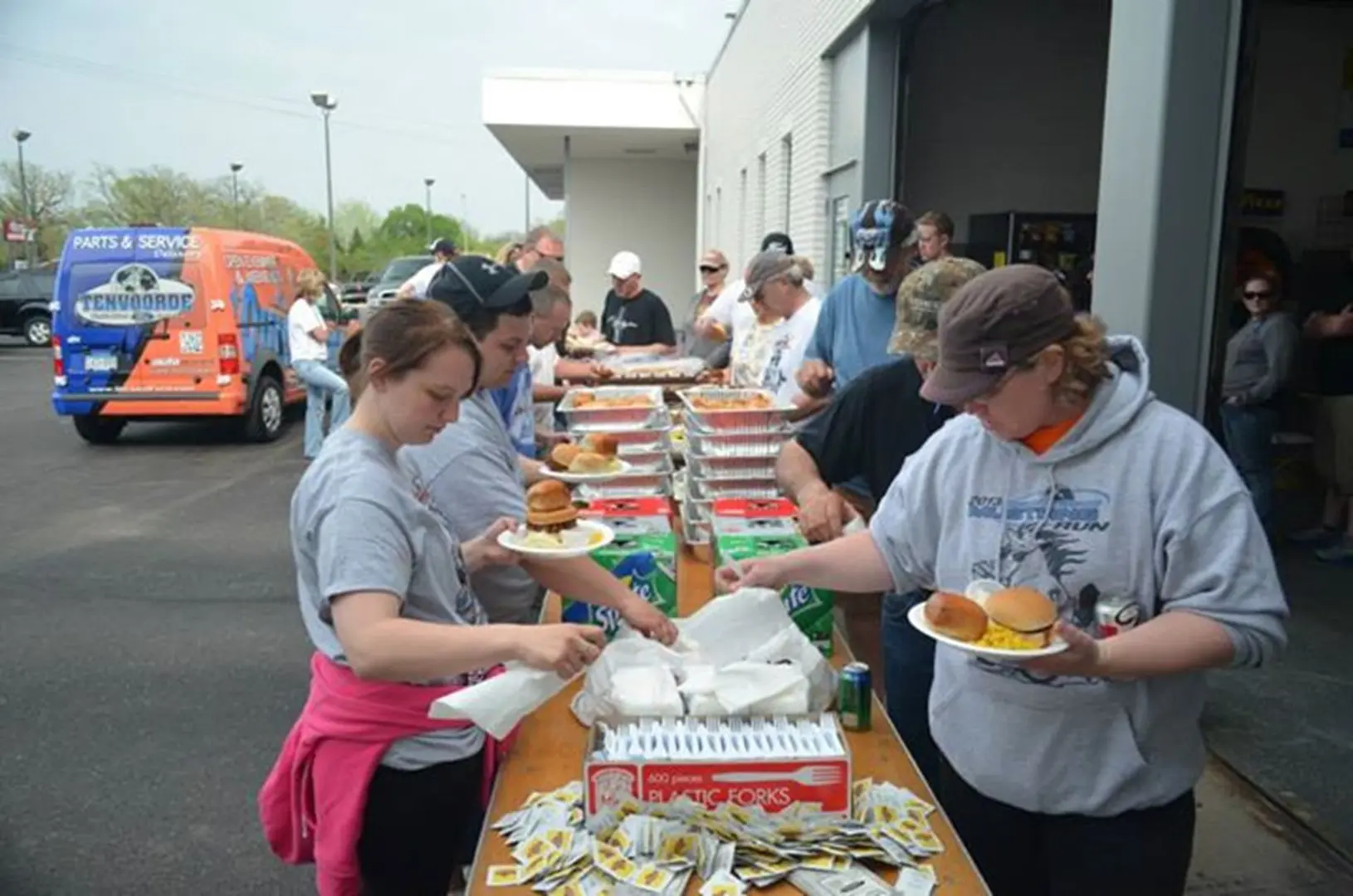 People serving food at outdoor event