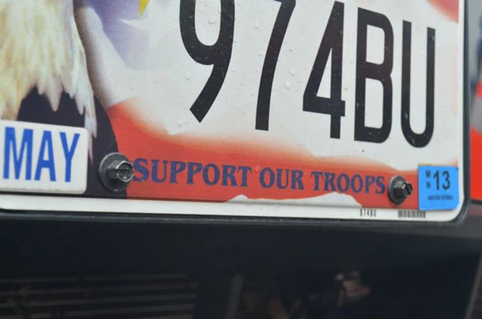 Car plate reads "Support Our Troops