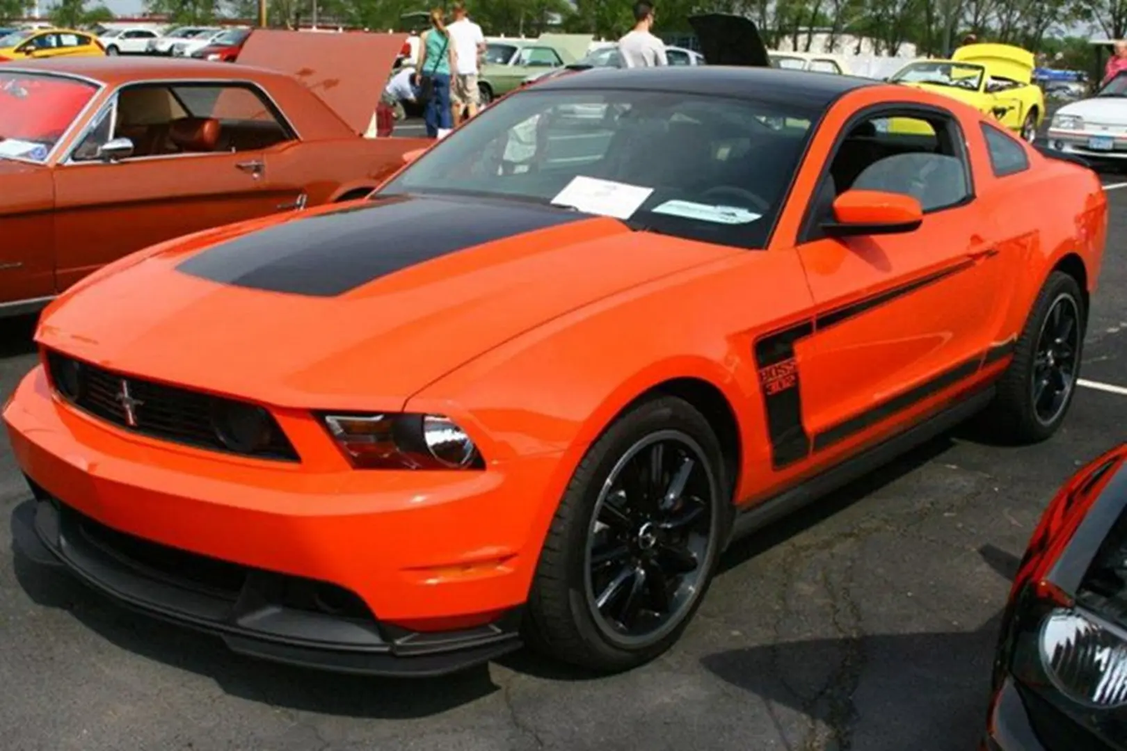 Orange sports car with black racing stripes