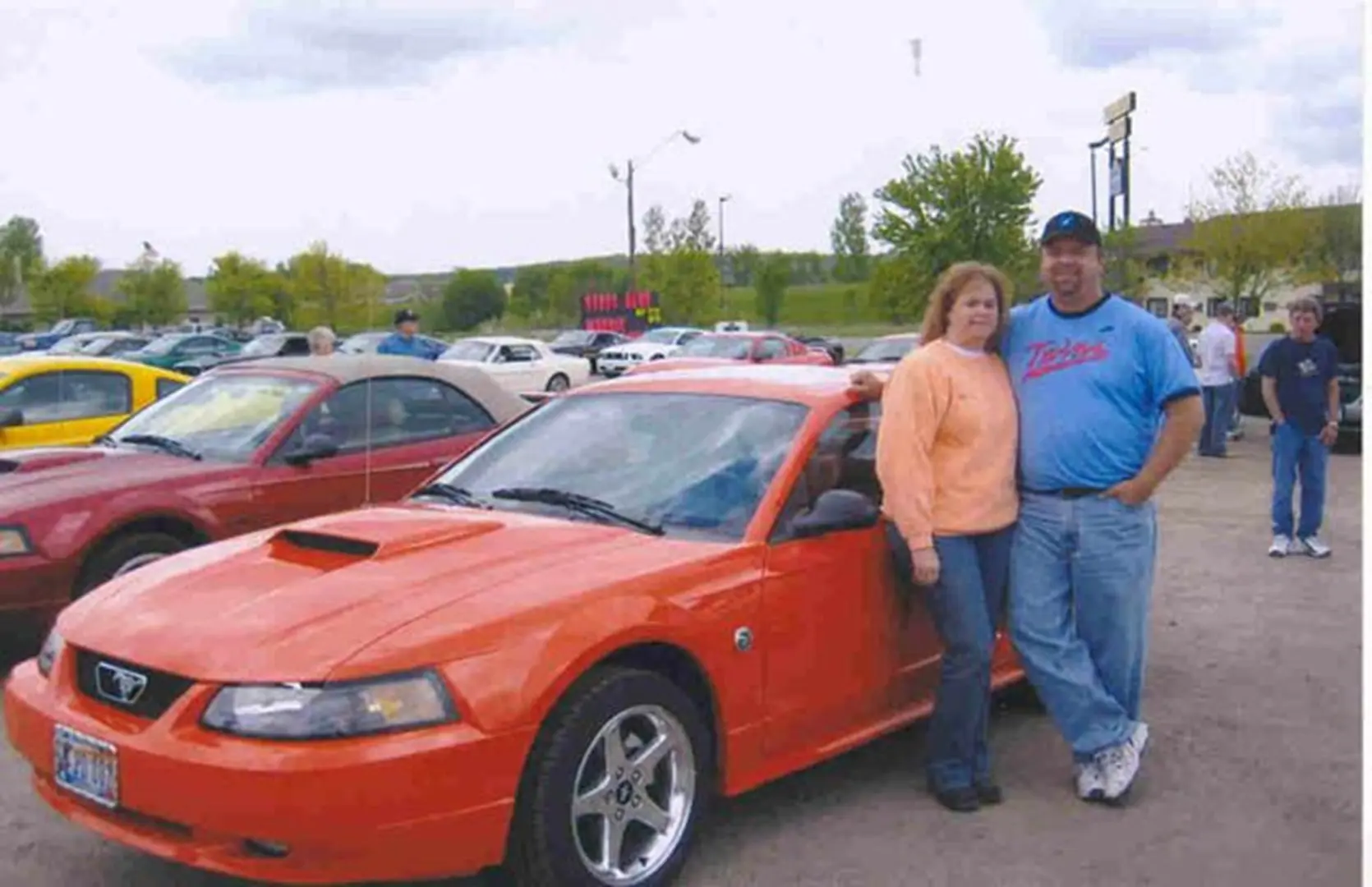 Man and woman with parked car