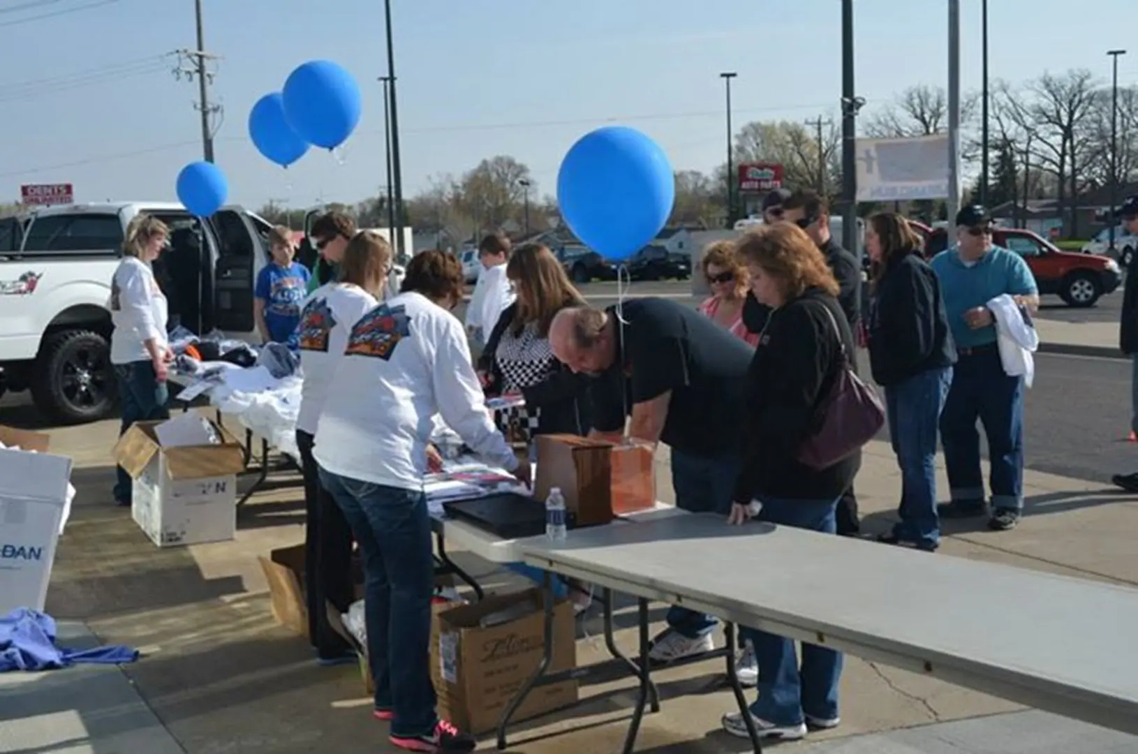 People gathering at registration table outside