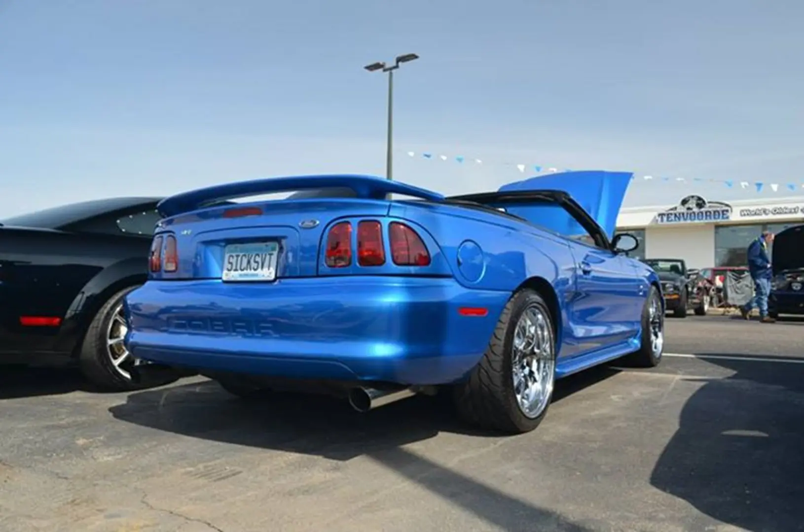 Blue convertible car with customized license plate