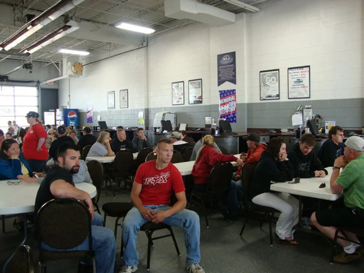 People sitting at tables in a waiting area