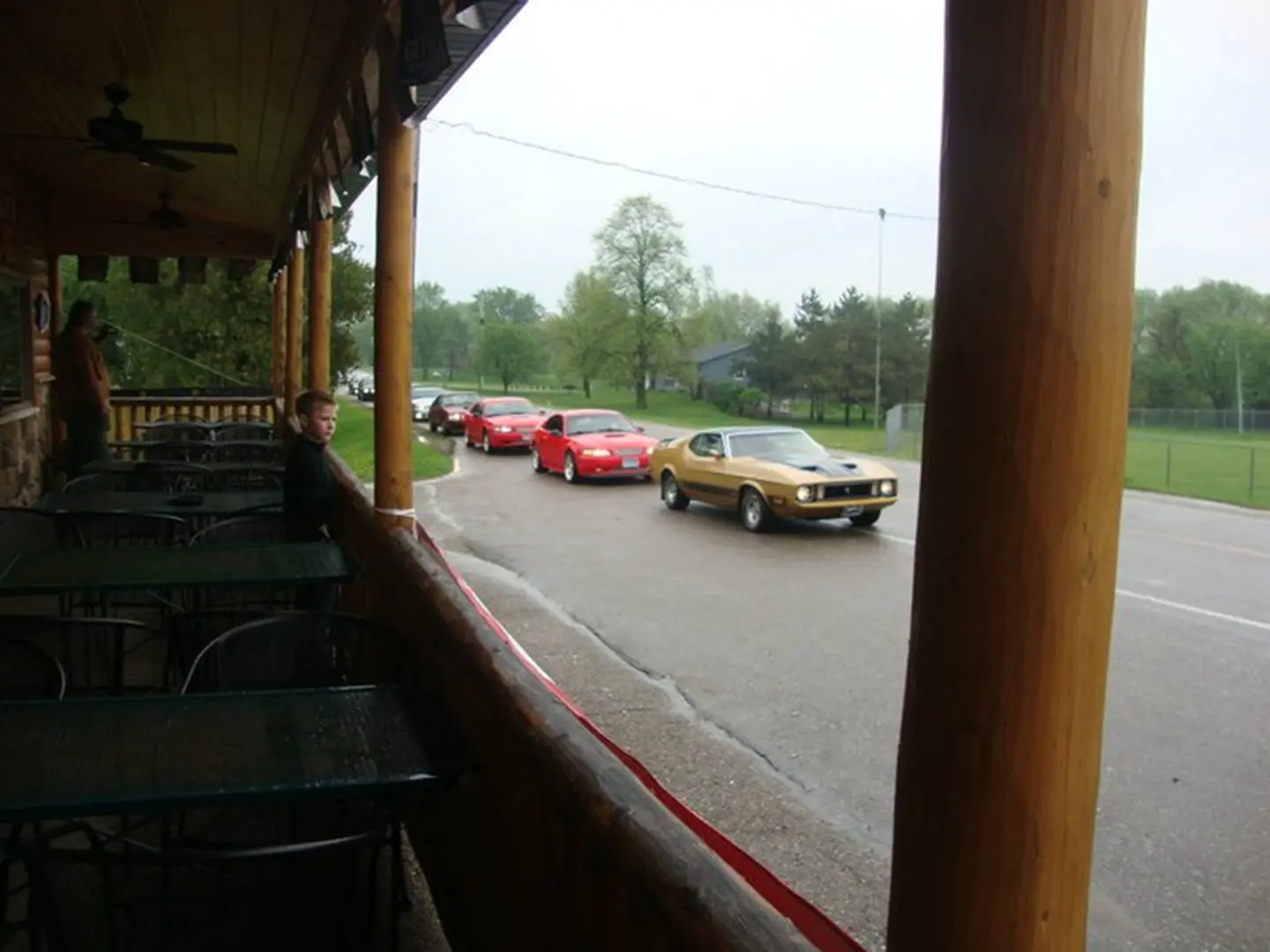 Cars parked outside a wooden porch