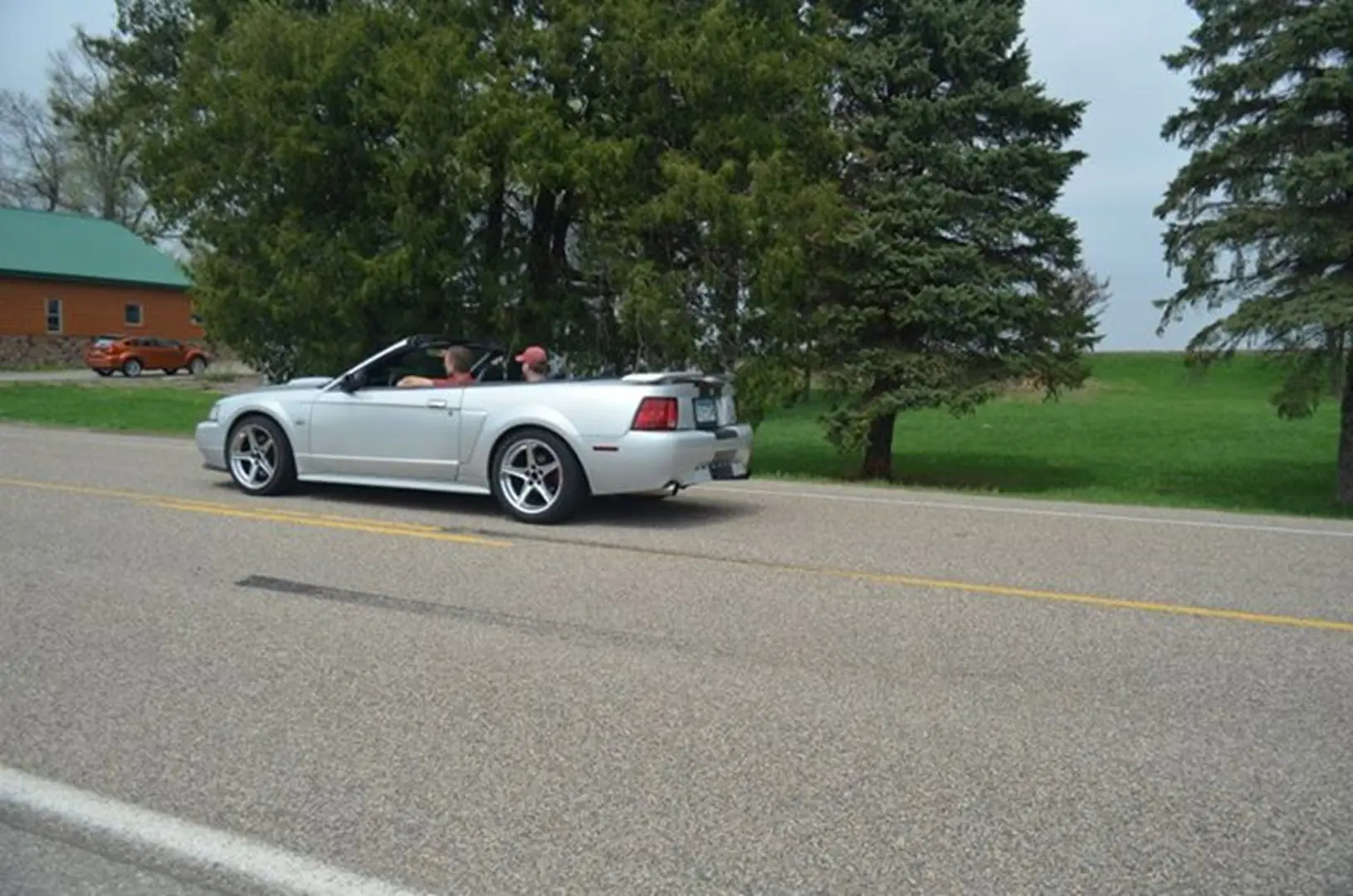 Silver convertible with trees in background