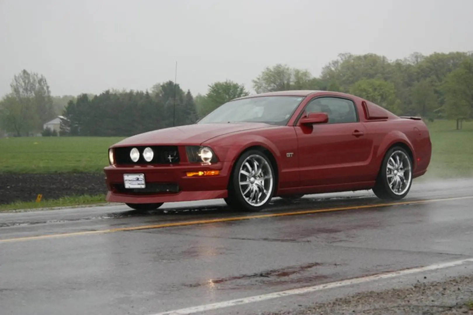 Classic car driving in rain