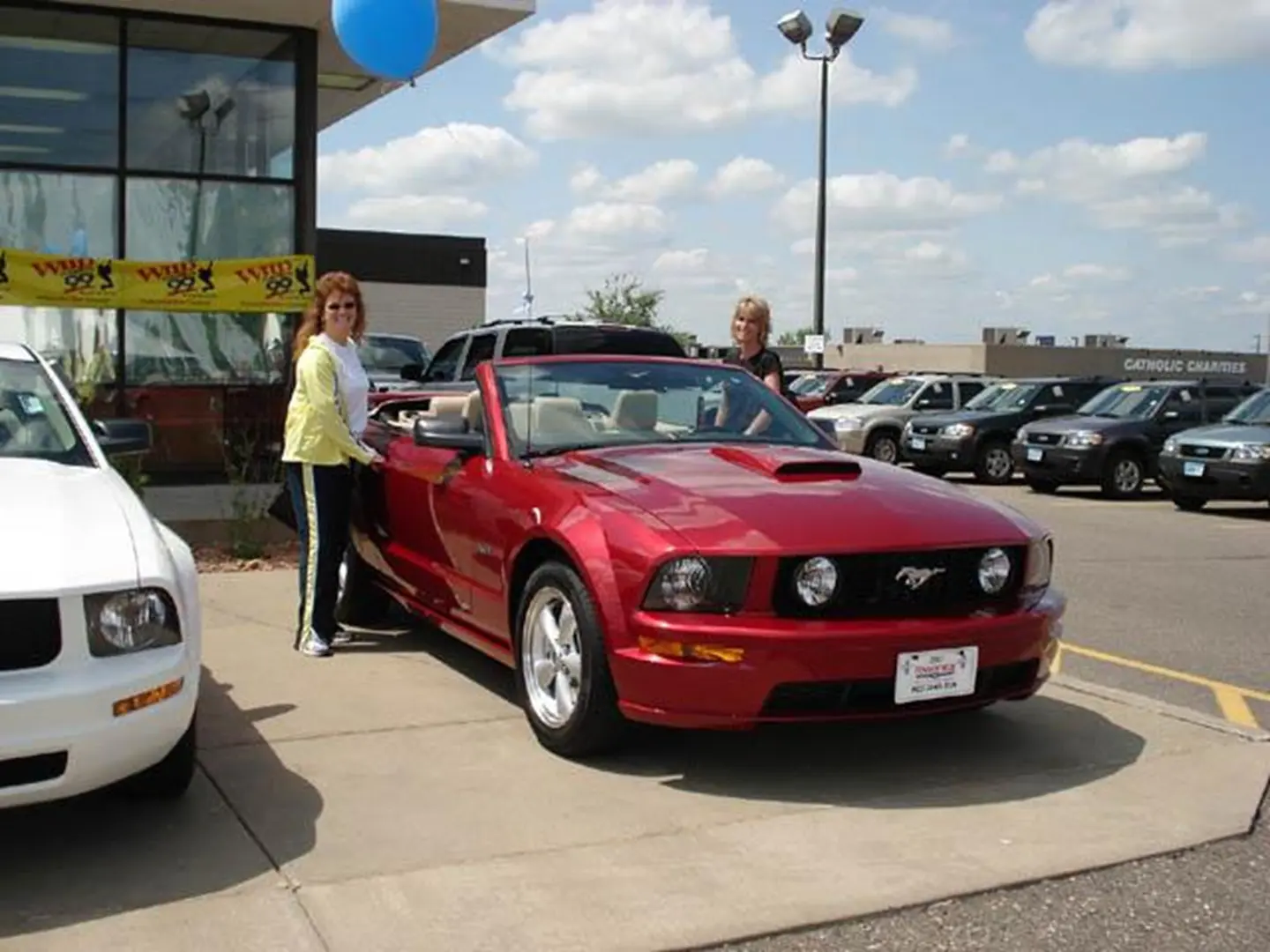 Sunny day at car dealership with Mustang