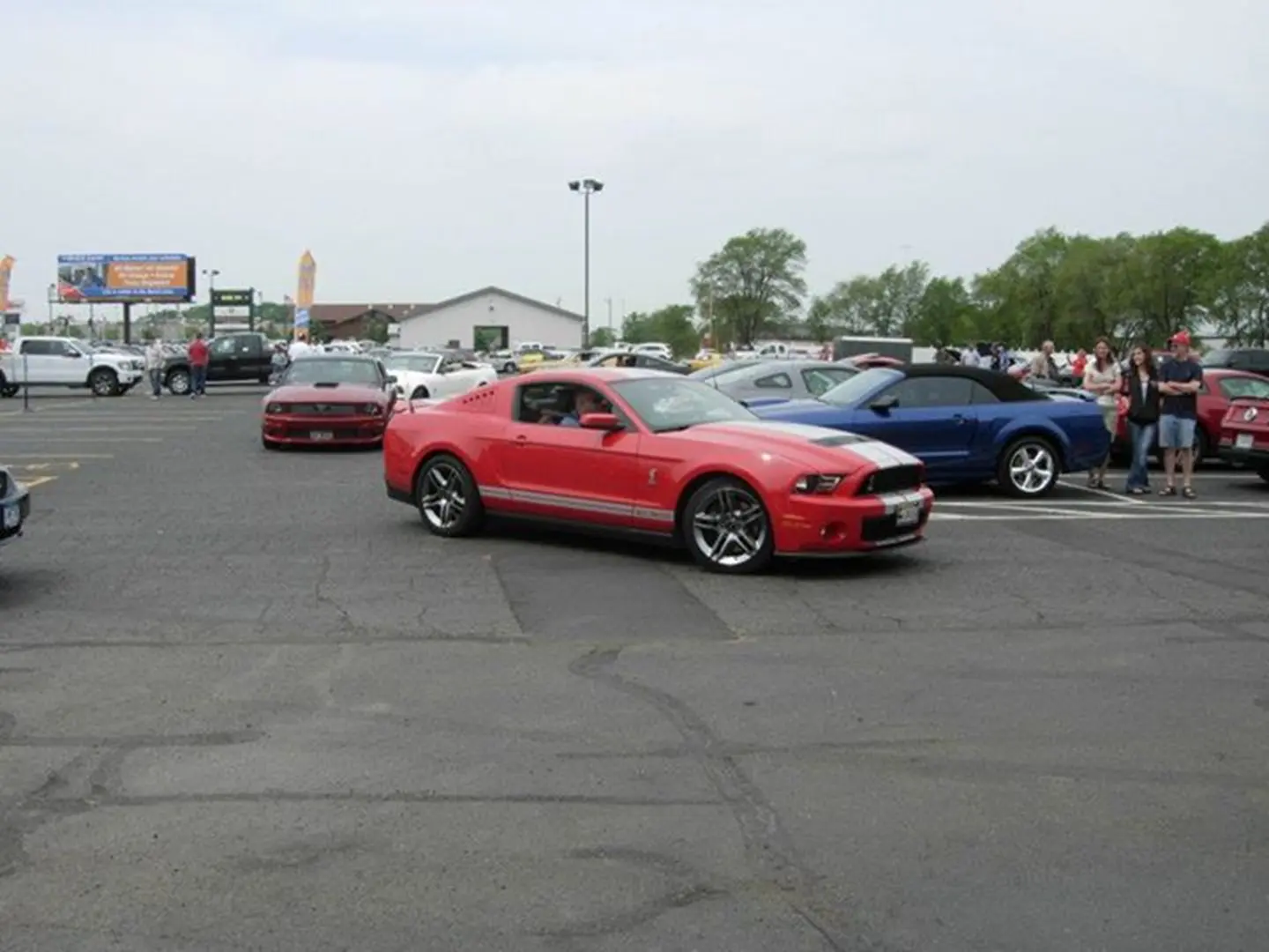Red sports car at outdoor car show