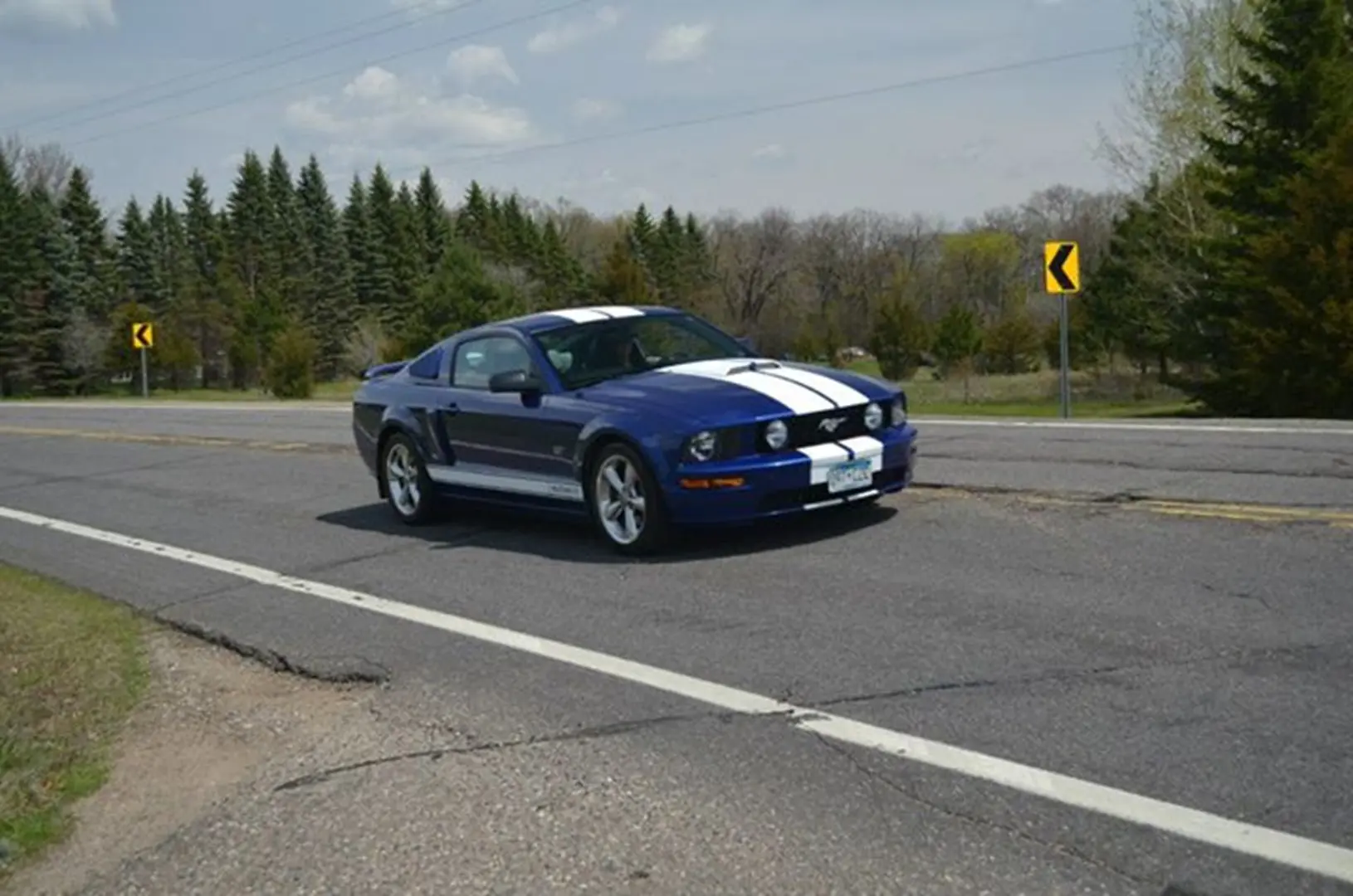 Mustang driving on a country highway