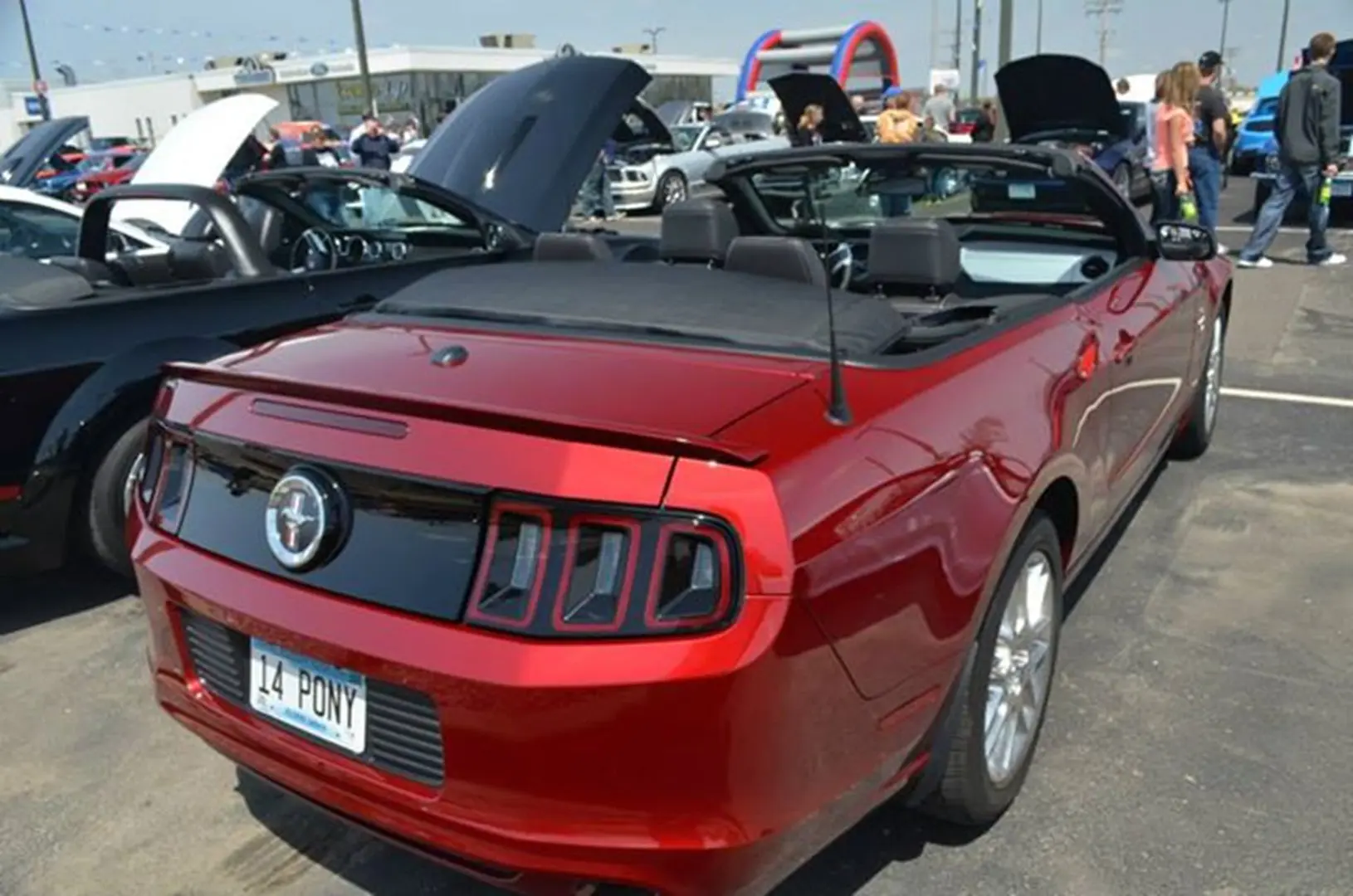 Red convertible car at a car show
