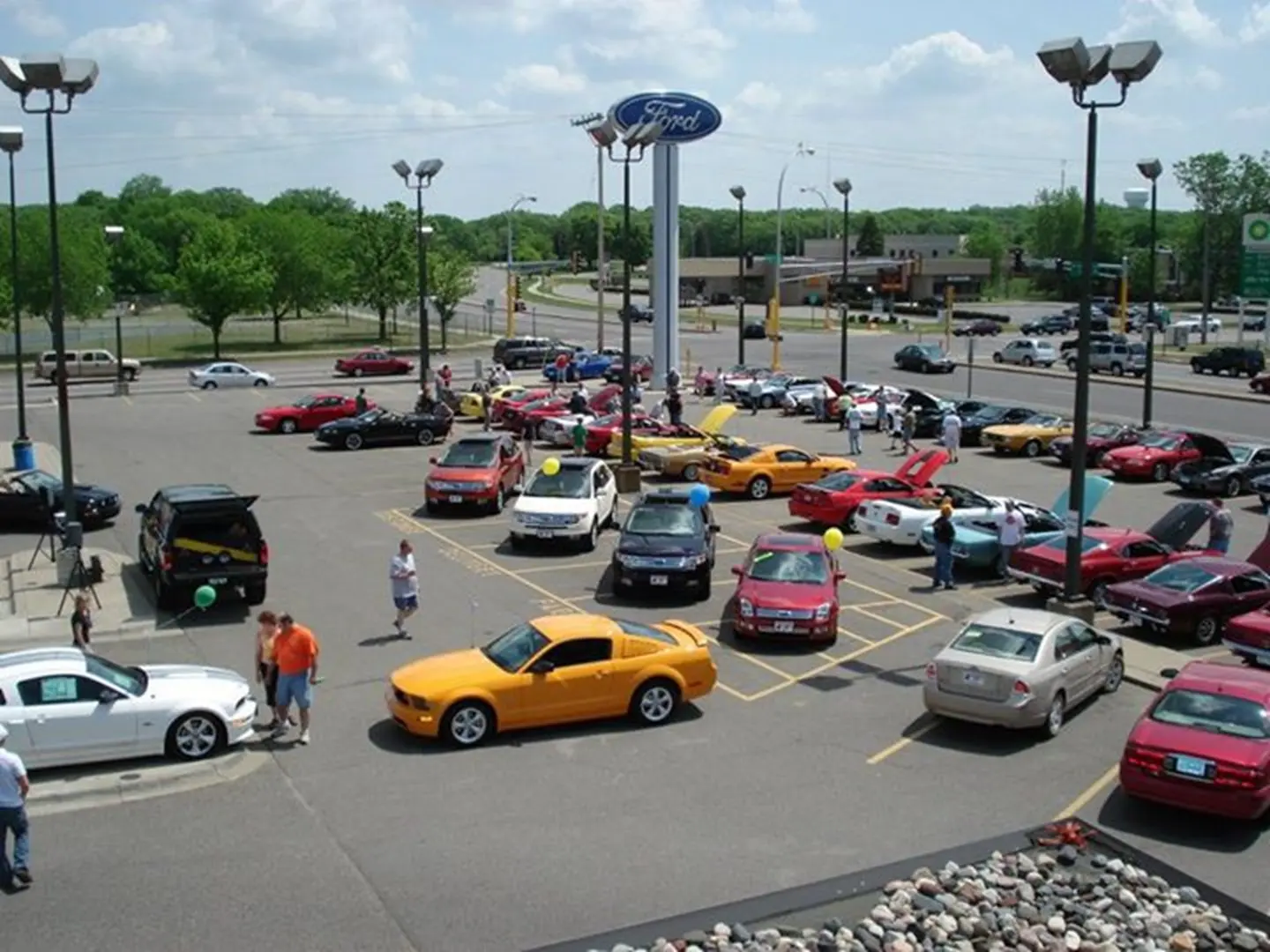 Auto enthusiasts gather in parking lot