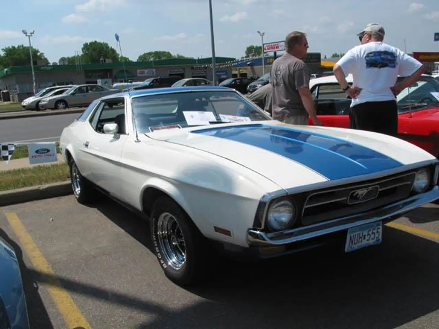 People admiring vintage Mustang