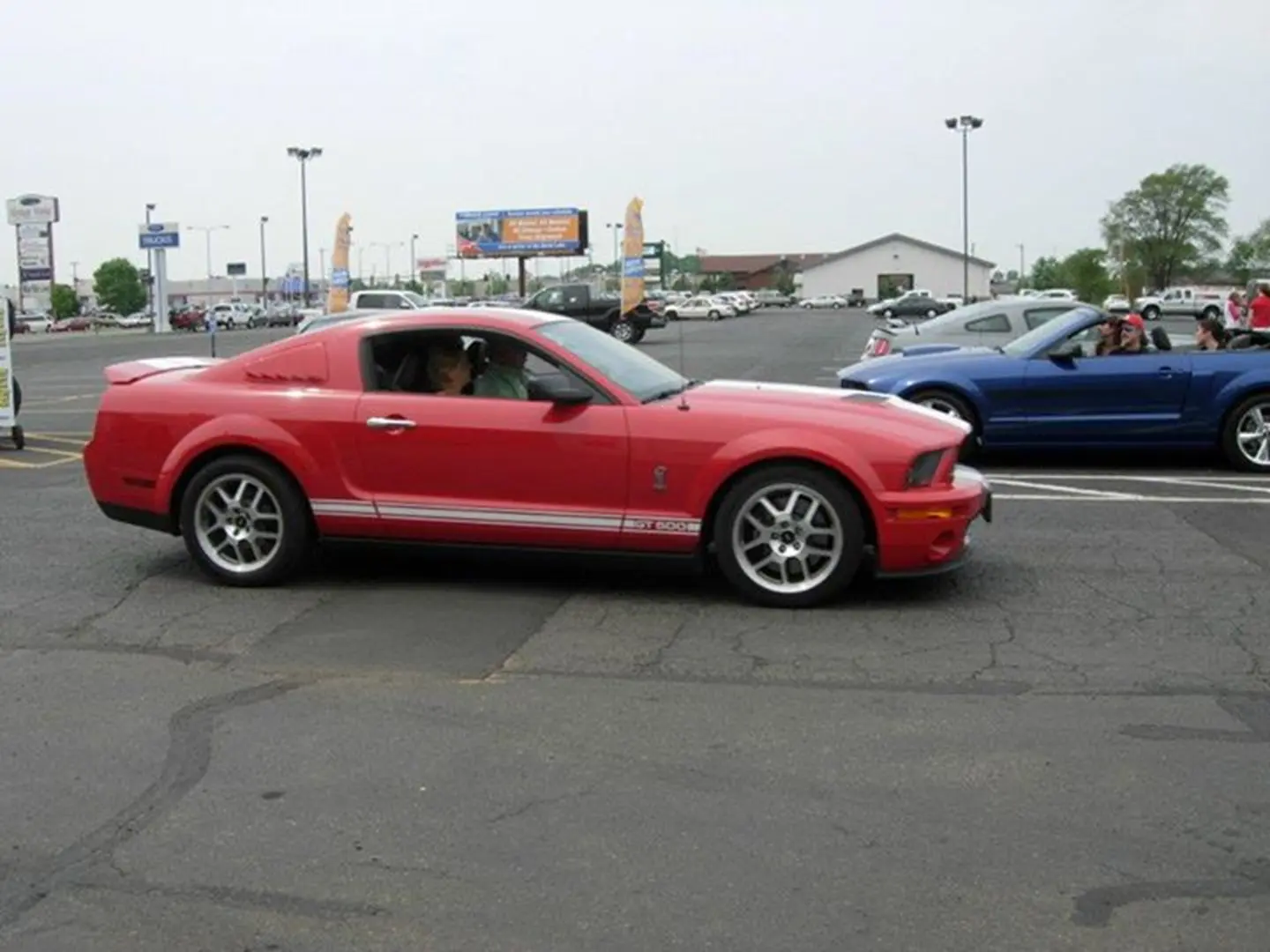 Red car beside blue car