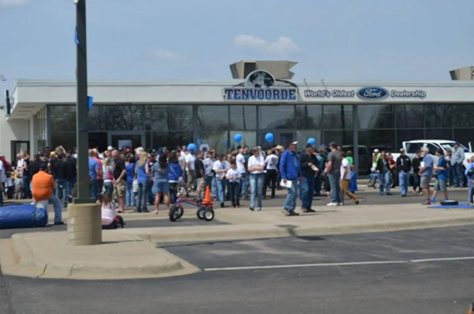People attending event at car dealership
