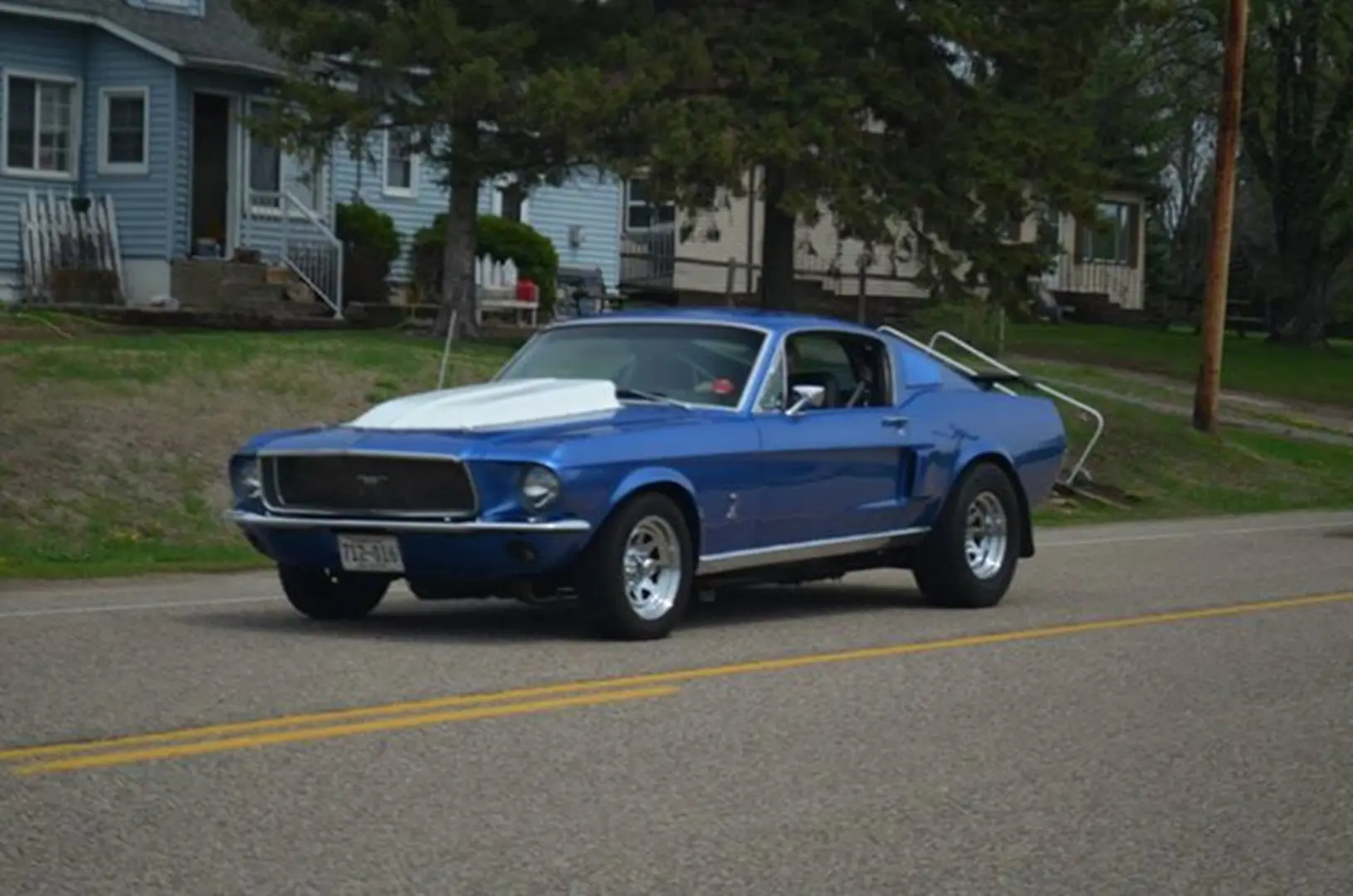 Retro blue car near houses