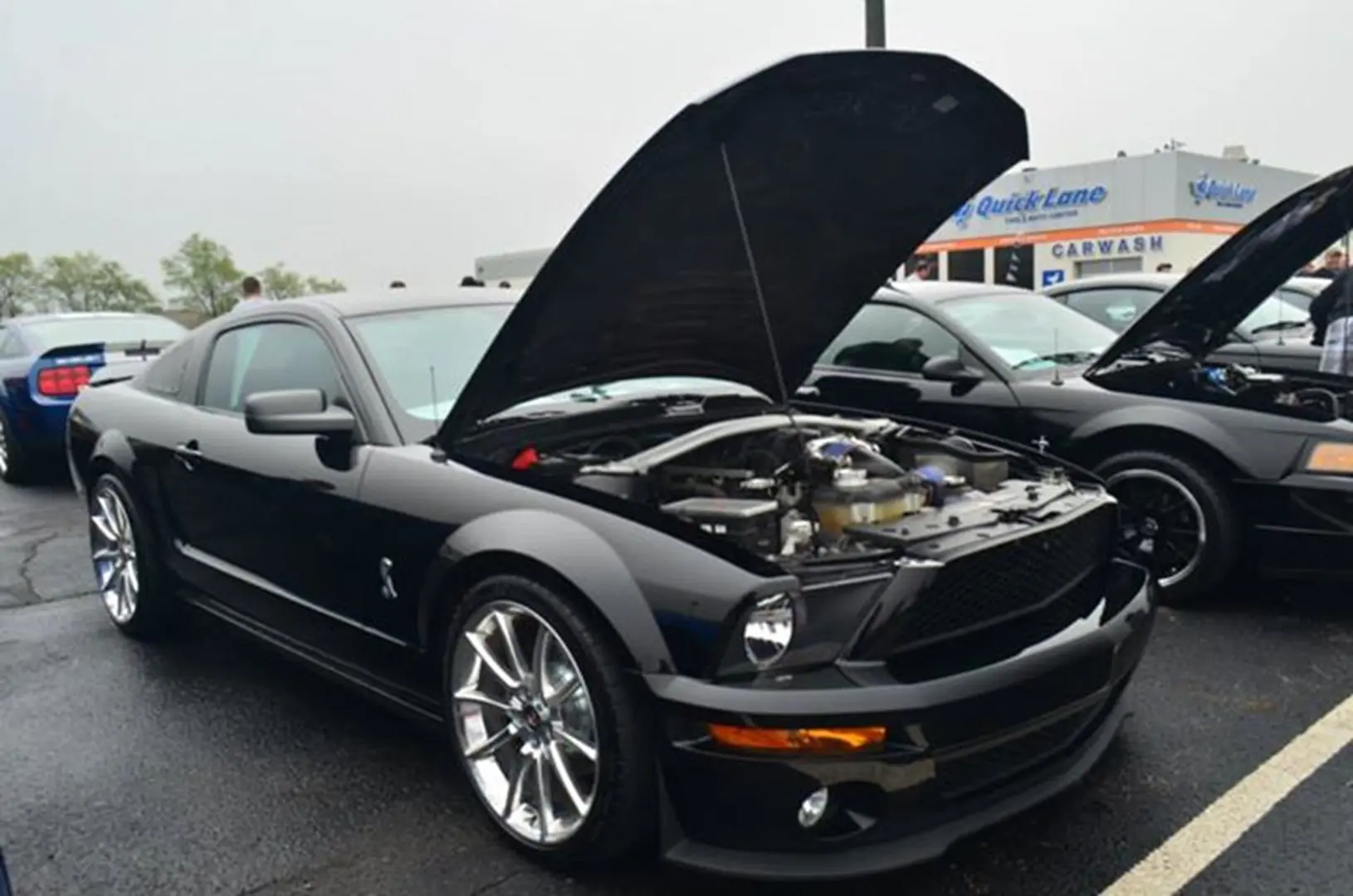 Black sports car with hood open
