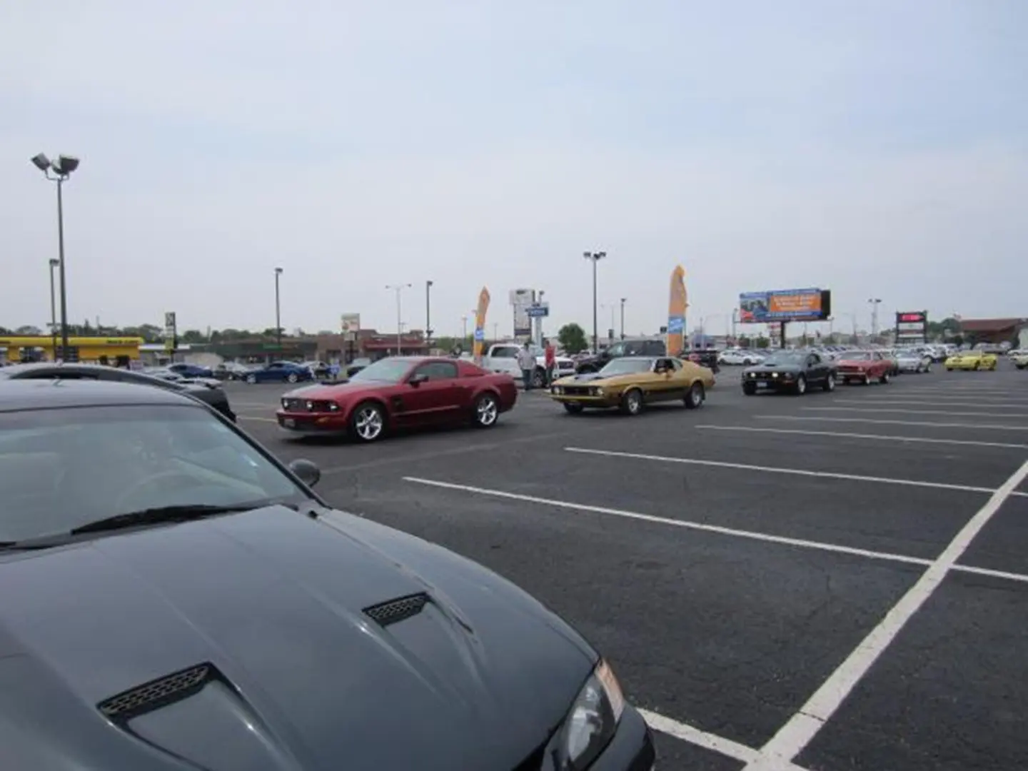 Classic and modern cars in parking lot.